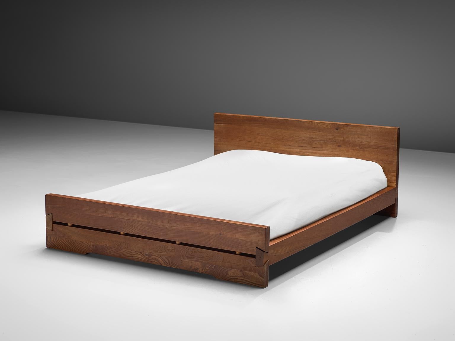 Pierre Chapo, 'Louis' bed L02D, elm, France, 1960s

This bed is designed by Pierre Chapo in the 1960s. The bed features the hand-crafted joints that the woodworker Chapo is known for. The bed holds a tall headboard and a lower foot end. The elm has