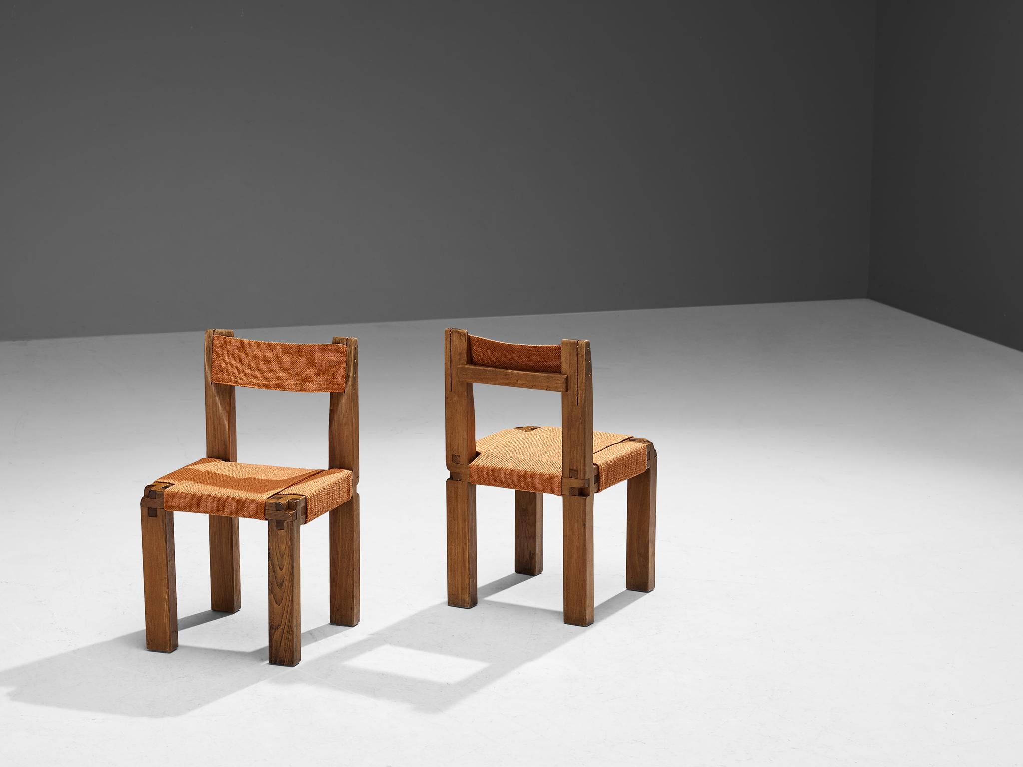 Pierre Chapo, pair of dining chairs model 'S11', elm, fabric, France, circa 1966.

This design is an early edition, created according to the original craft methodology of Pierre Chapo. A pair of chairs in solid elmwood with orange fabric seating and