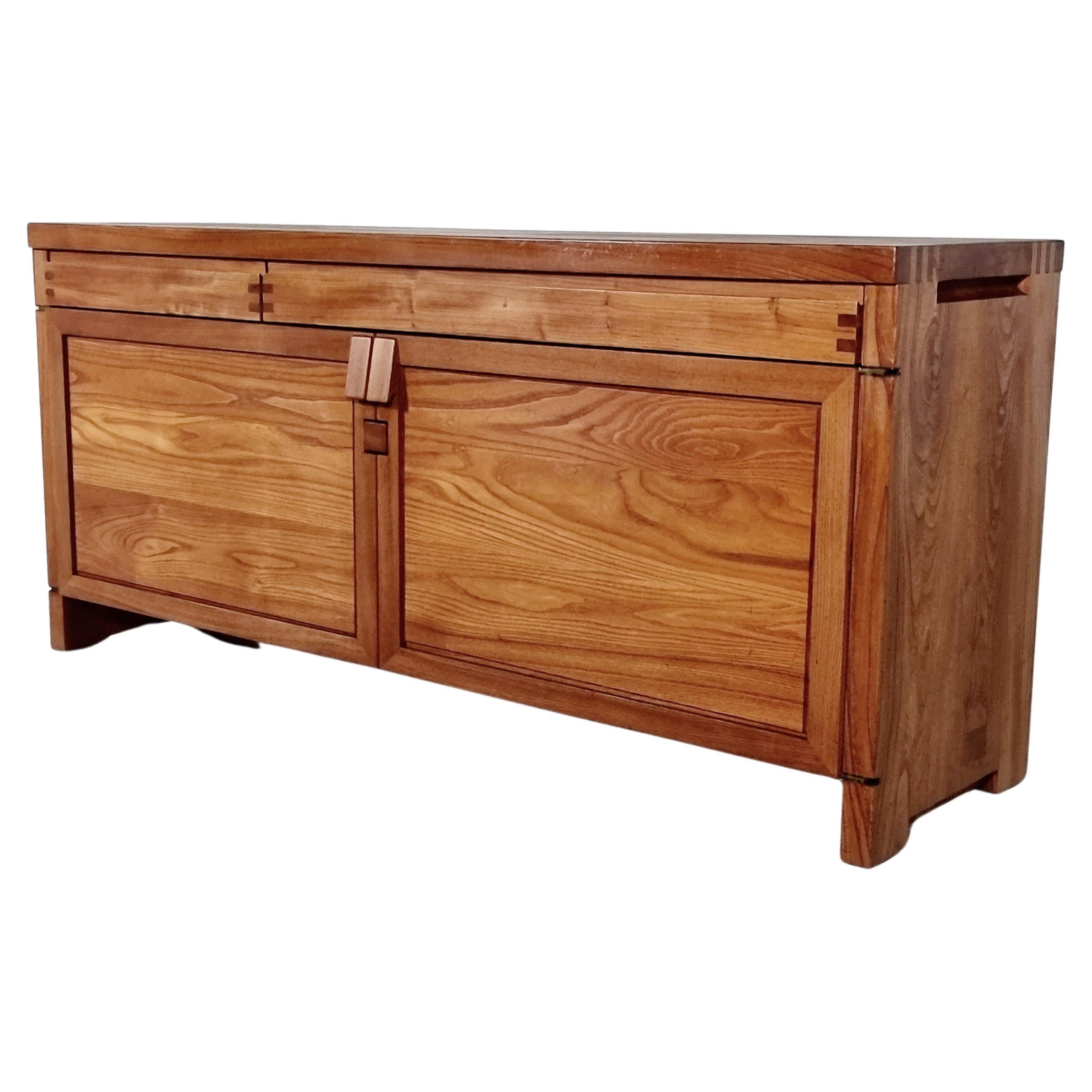 Pierre Chapo, sideboard, Model R08, elm, France, circa 1964.

This stunning credenza combines a simplified yet complex design with nifty, solid construction details that characterize Chapo's work. The well-proportioned doors and drawers are