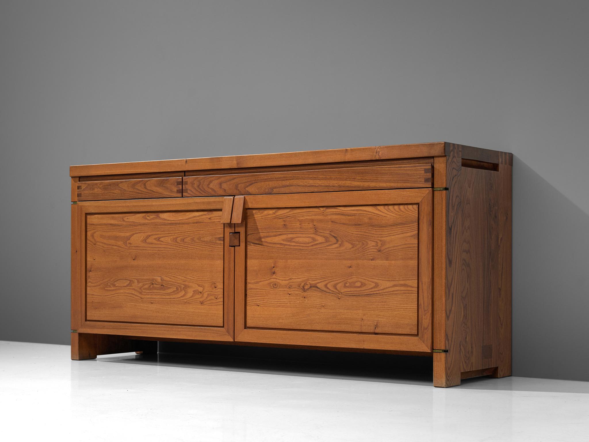 Pierre Chapo, sideboard, Model R08, elm, France, circa 1964.

This exquisitely crafted credenza combines a simplified yet complex design combined with nifty, solid construction details that characterize Chapo's work. The well-proportioned doors
