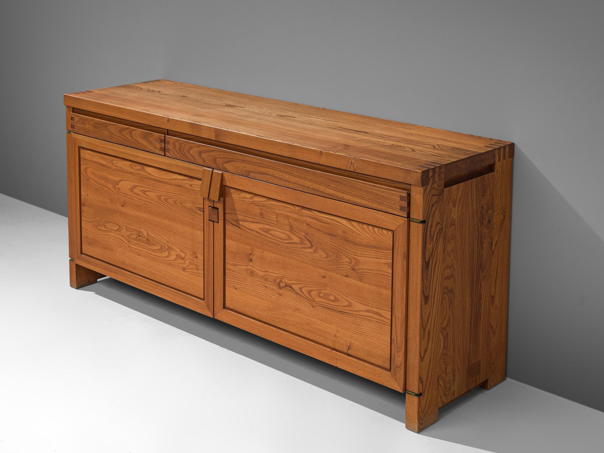 Pierre Chapo, sideboard, Model R08, elm, France, circa 1964.

This exquisitely crafted credenza combines a simplified yet complex design combined with nifty, solid construction details that characterize Chapo's work. The well-proportioned doors and