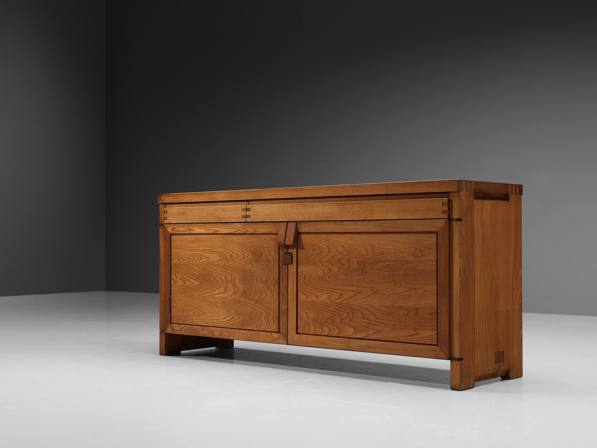 Pierre Chapo, sideboard, model 'R08', elm, France, circa 1964.

This design is an early edition, created according to the original craft methodology of Pierre Chapo. This exquisitely crafted credenza combines a simplified yet complex design combined