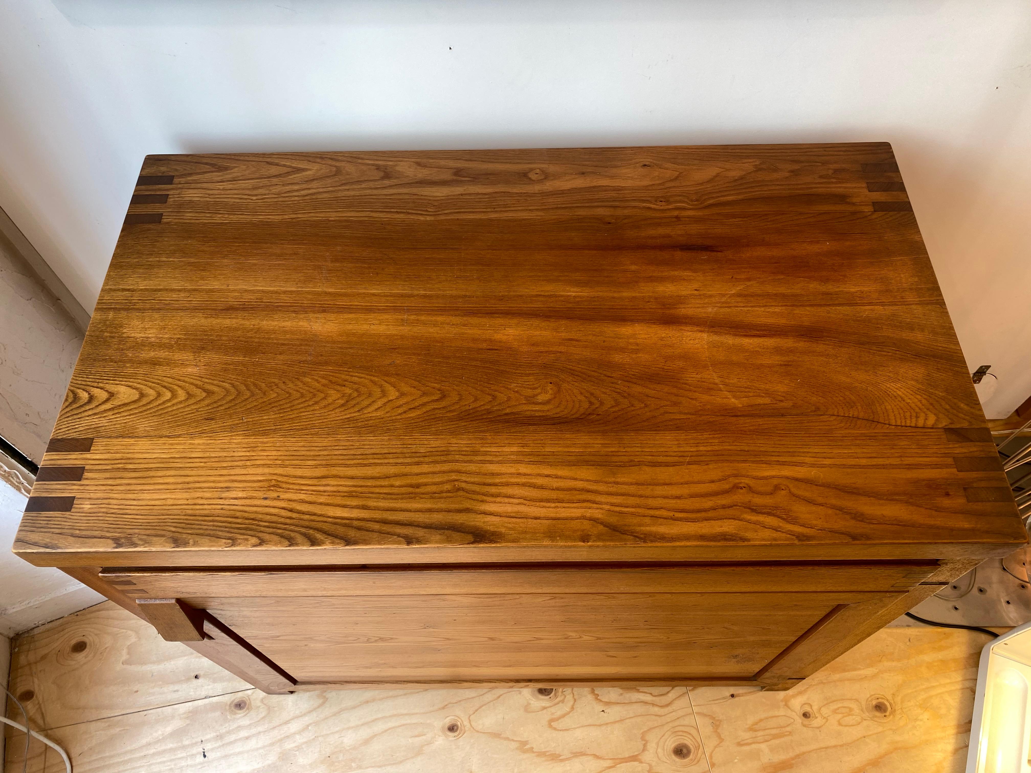 Pierre Chapo R09 
Piece of furniture in solid elm with a support height
Openable by a drawer in a belt and by a door leaf
circa 1975.
Measures: H 84 x W 96 x D 53
3900 Euros.