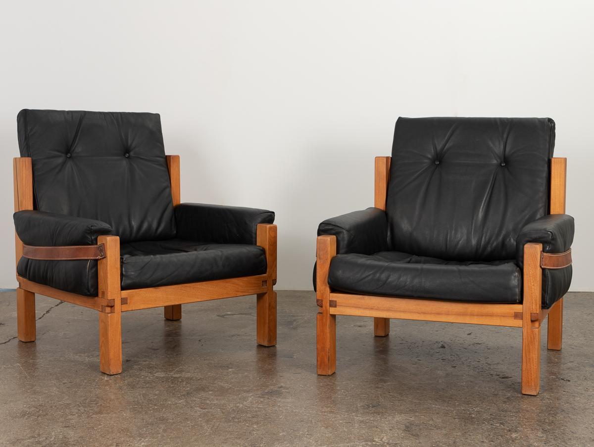 Fantastic pair of Model S15 ‘comfort’ lounge chairs in elm and black leather, designed by Pierre Chapo and crafted in his own atelier. An understated, boxy form, with design details that showcase exquisite craftsmanship. Signature exposed joints add