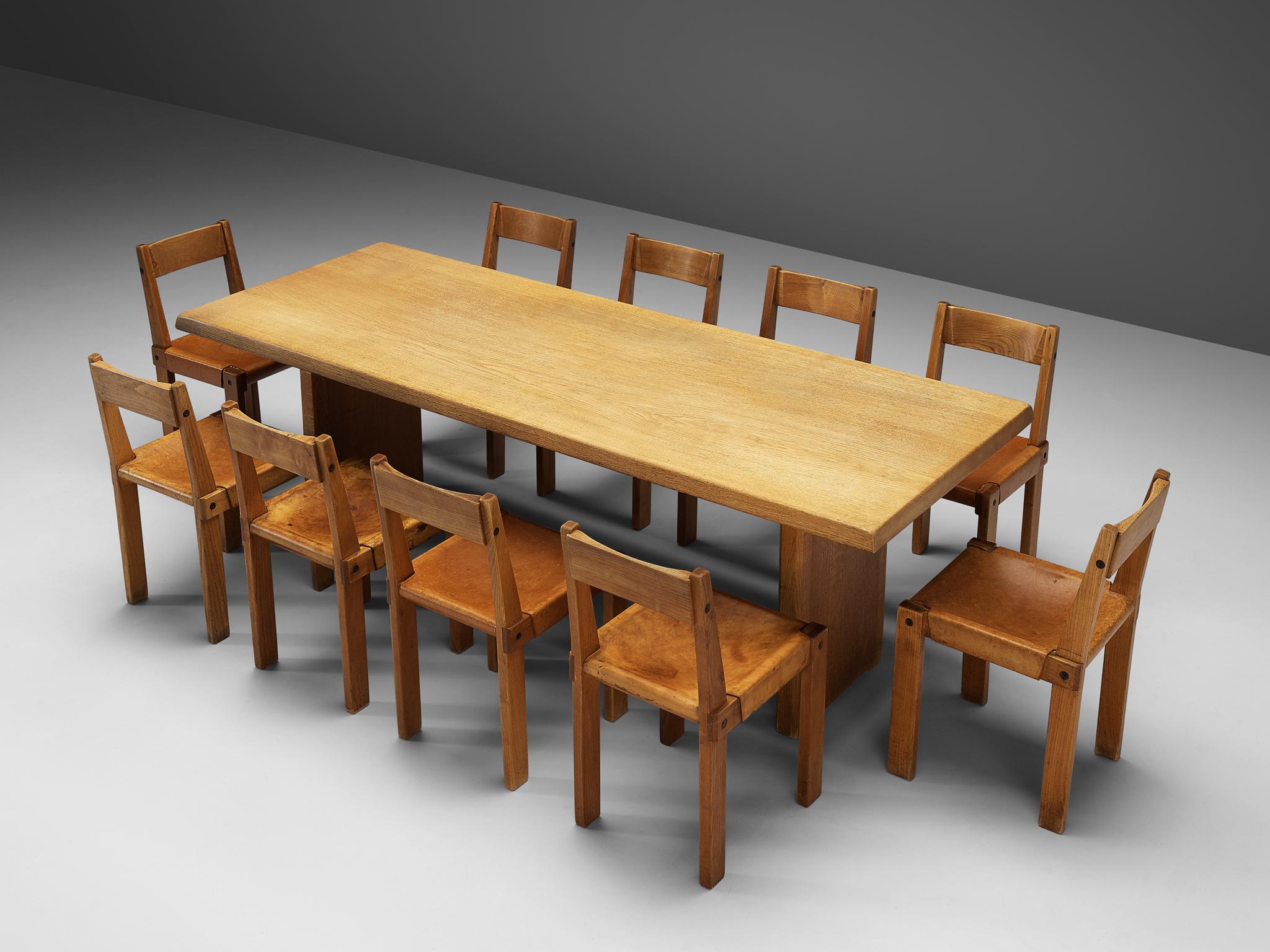 Pierre Chapo, set of ten dining chairs, model S24, elm and leather, France, circa 1966
Pierre Chapo, dining table model T14D, oak, France, design 1960s, production 1970s.

A set of ten chairs in solid elmwood with saddle leather seating and back.