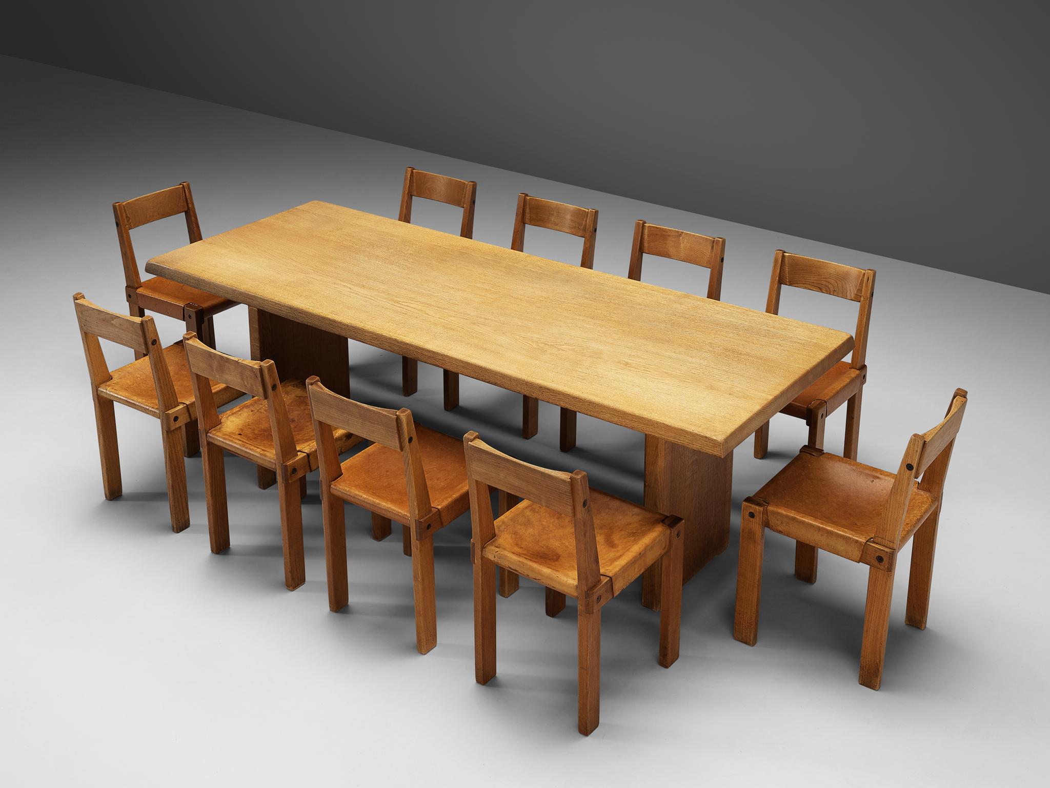 Pierre Chapo, set of ten dining chairs, model S24, elm and leather, France, circa 1966
Pierre Chapo, dining table model T14D, oak, France, design 1960s, production 1970s

A set of ten chairs in solid elmwood with saddle leather seating and back.