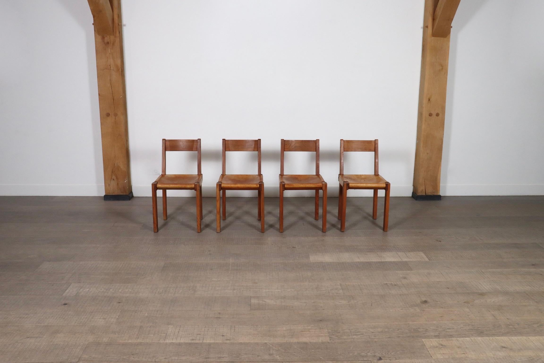Incredible set of four model S24 dining chairs by renowned French designer Pierre Chapo, designed in France in the 1960s. The thick cognac saddle leather is stunningly patinated during usage and age and show interesting character. The immaculate