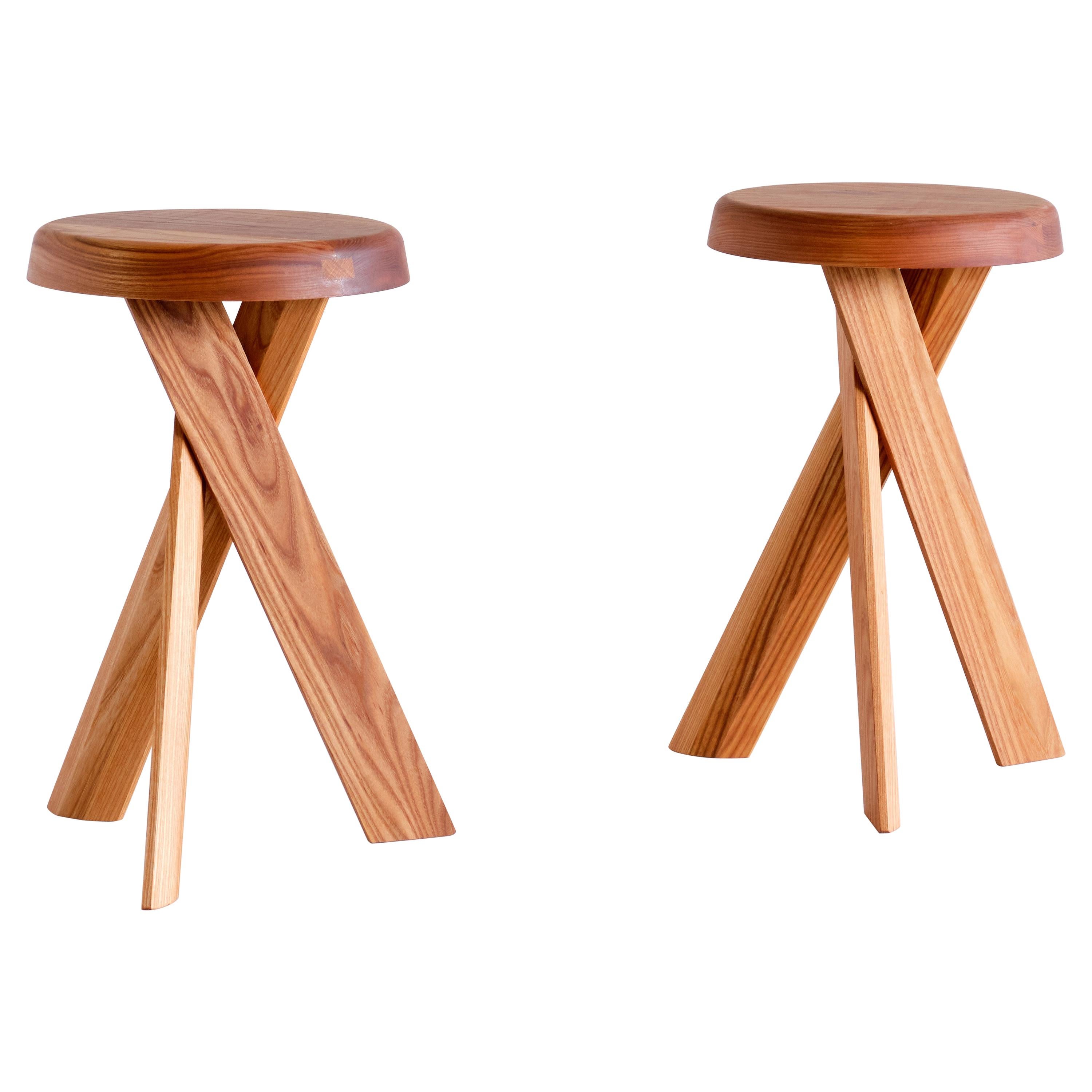 This striking three-legged stool is the model S31 designed by Pierre Chapo in 1974. The cross legged base and round seat are in solid elm wood. This stool also (could work) works well as a small side table.

We have three pieces in stock available