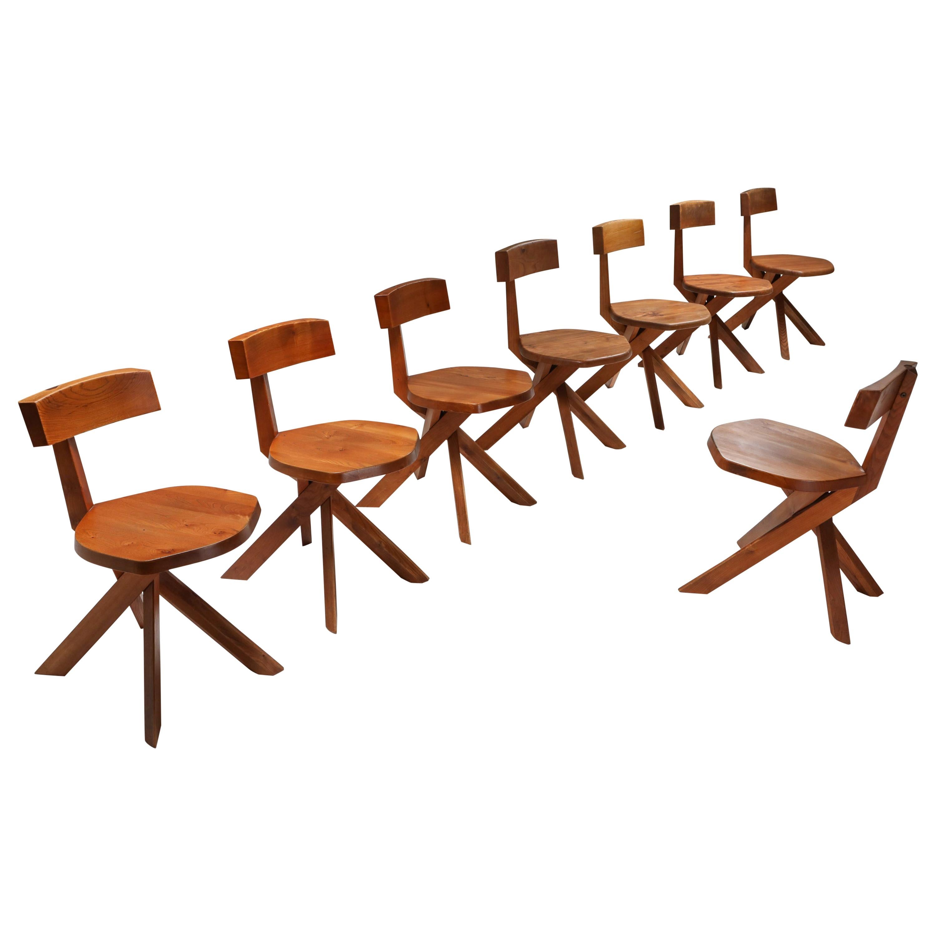 Pierre Chapo, Mid-Century Modern, solid elm S34 dining chairs, France, 1960s.

These chairs have the typical playful and majestic characteristics of Pierre Chapo's iconic designs. Asymmetric but yet in perfect balance.
The cross-legged base matches