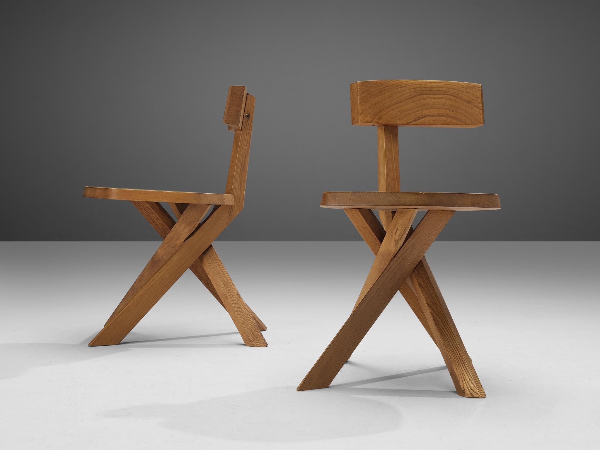 Pierre Chapo, dining chairs, model 'S34', elm, France, circa 1973

This asymmetrical pair of dining chairs with a twisted base are true icons of Pierre Chapo's playful and solemn designs. The backrest is placed just slightly out of the middle which