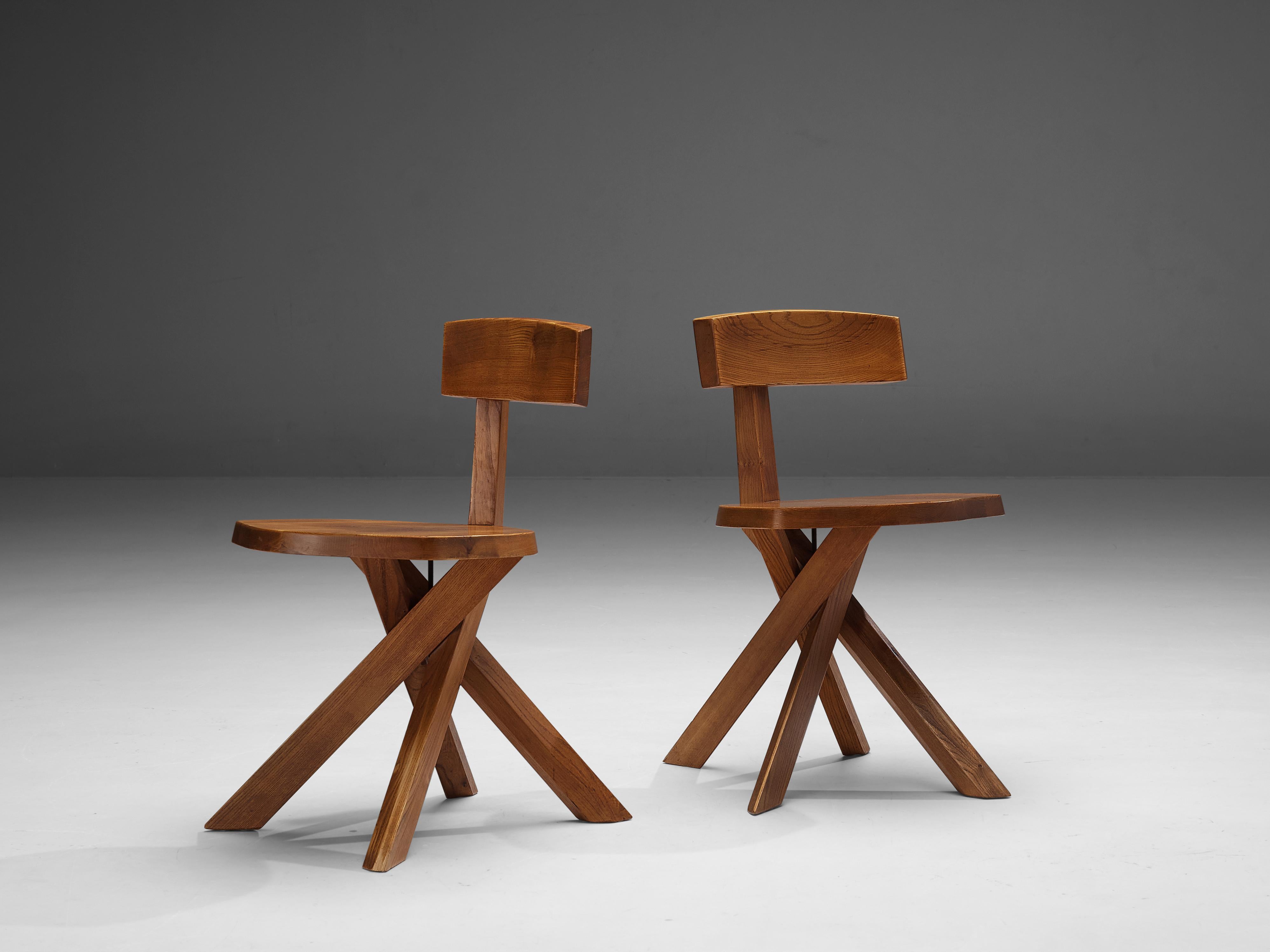 Pierre Chapo, dining chairs model 'S34', elm, France, 1960s

These asymmetrical chairs with a twisted base are true icons of Pierre Chapo's playful and solemn designs. The backrest is placed just slightly out of the middle which strengthens the