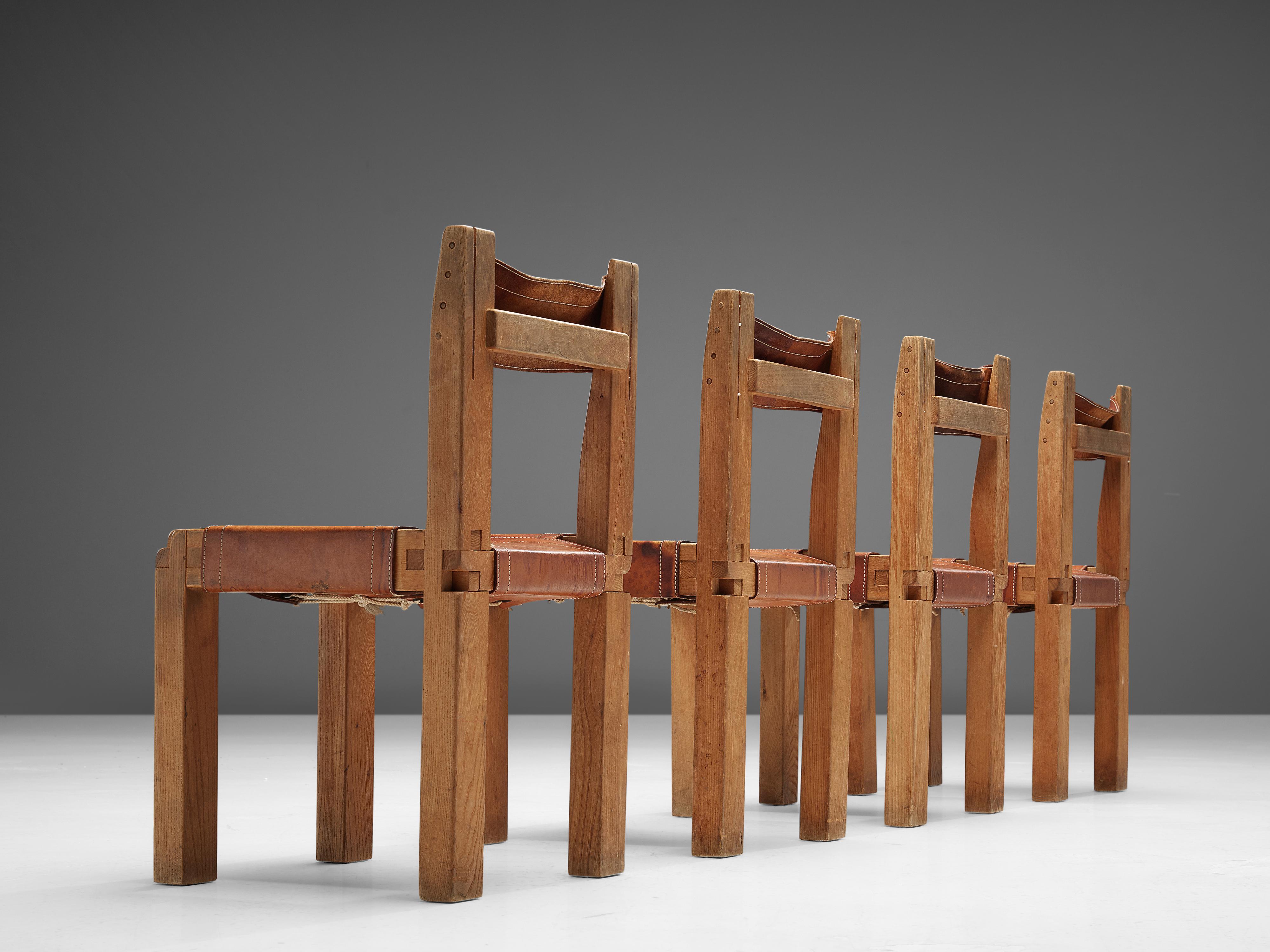 Pierre Chapo, set of four dining chairs, model 'S11', elm, leather, France, circa 1966. 

A set of four chairs in solid elmwood with cognac leather seating and back, designed by French designer Pierre Chapo. These chairs have a cubic design of