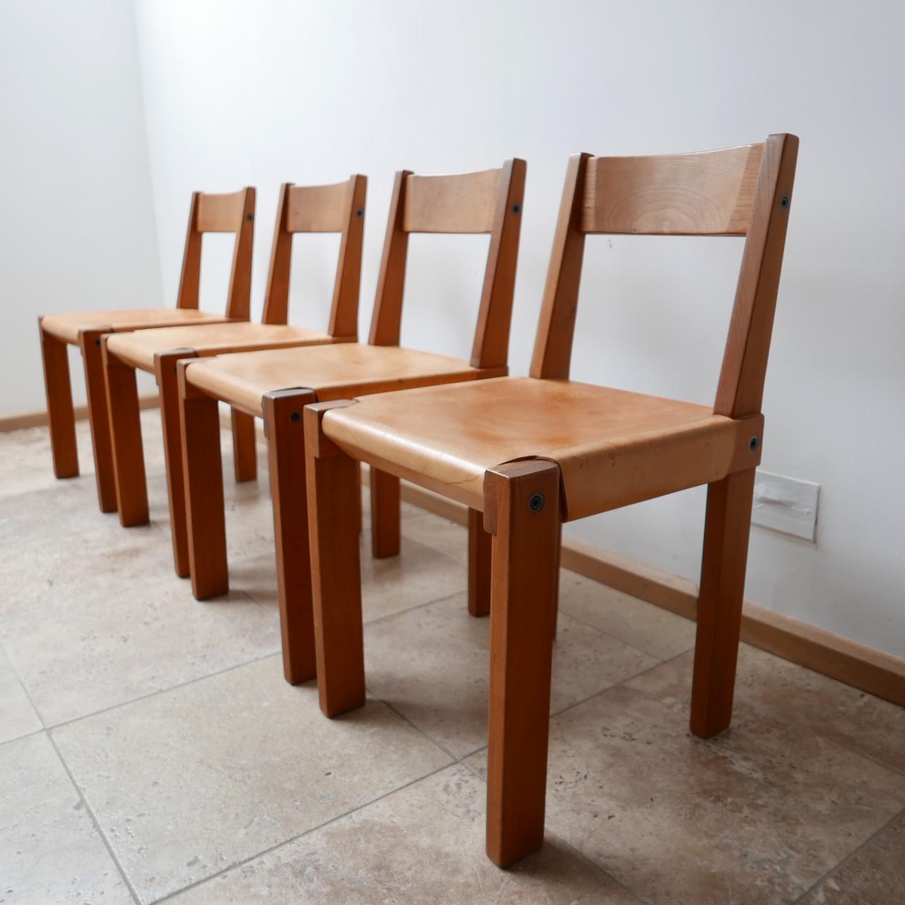 A run of four original Pierre Chapo dining chairs. 

S24 Model. 

French elm and leather. 

There is some staining to the leather consistent with age. 

France, c1970s. 

Dimensions: 41.5 W x 43 D x 44 Seat Height x 76.5 Total Height in