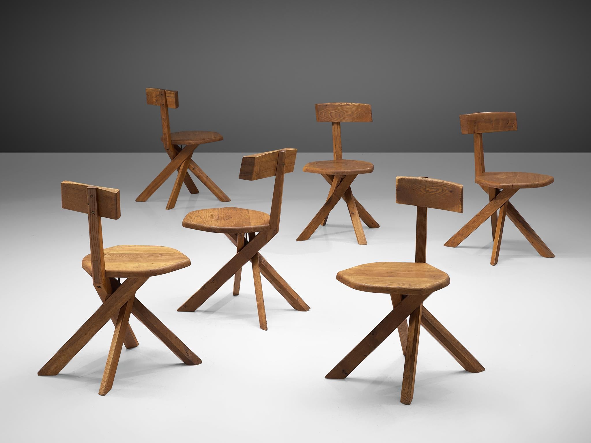 Pierre Chapo, set of six 'S34' dining chairs, elmwood, France, 1960s

These asymmetrical chairs with twisted base are true icons of Pierre Chapo's playful and solemn designs. The backrest is placed just slightly out of the middle, this