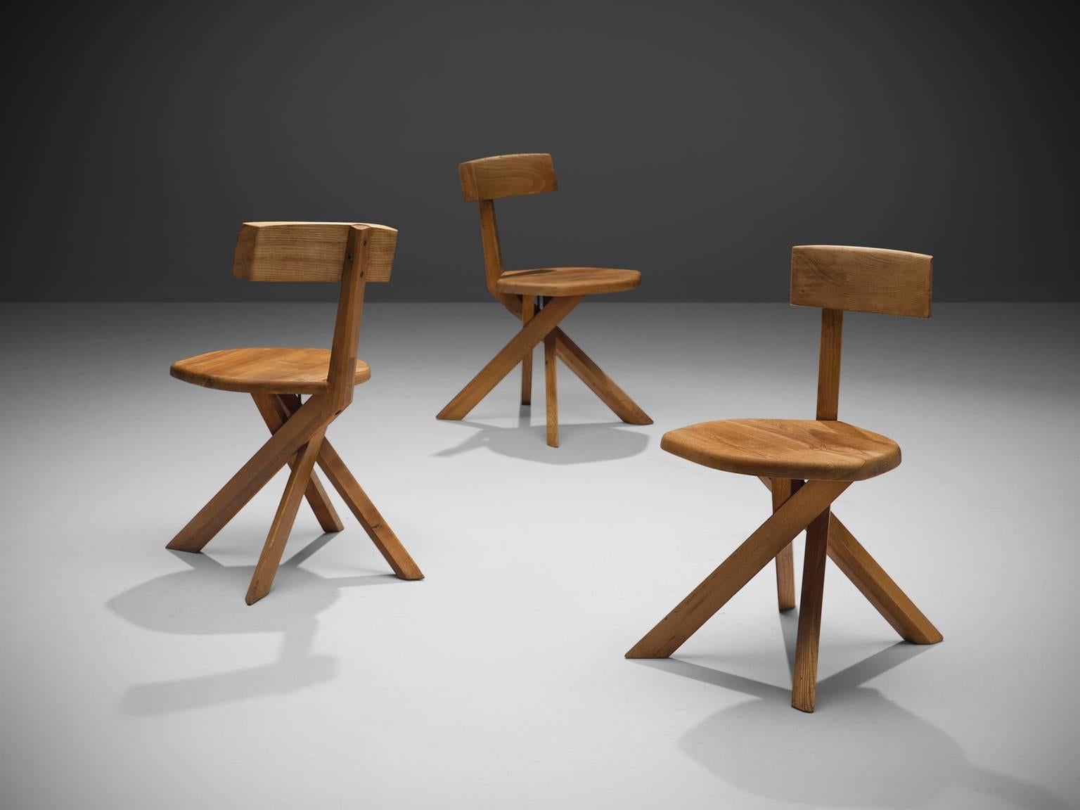 Pierre Chapo, three chairs S34, elm, France, 1960s.

These three asymmetrical chairs with twisted base are icons of Pierre Chapo's playful and solemn designs. The backrest is placed just slightly out of the middle, this imperfection has to result of