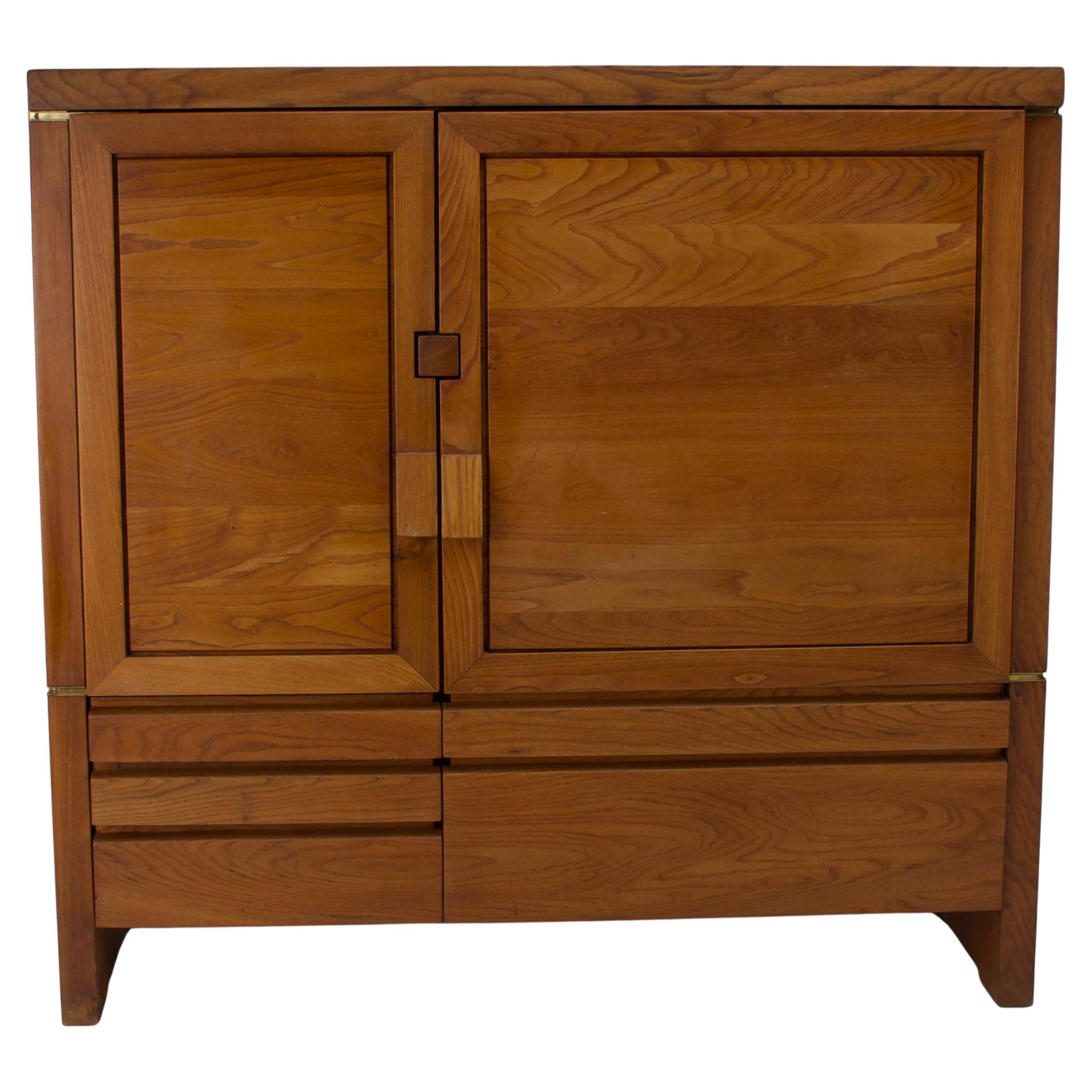 Impressive cabinet/sideboard by Pierre Chapo, model R18, France, 1960s.   The sideboard is made of solid elmwood with a high section double swing doors and 5 drawers on the front and sculptural handles. Beautifully crafted enhancing the wood grain