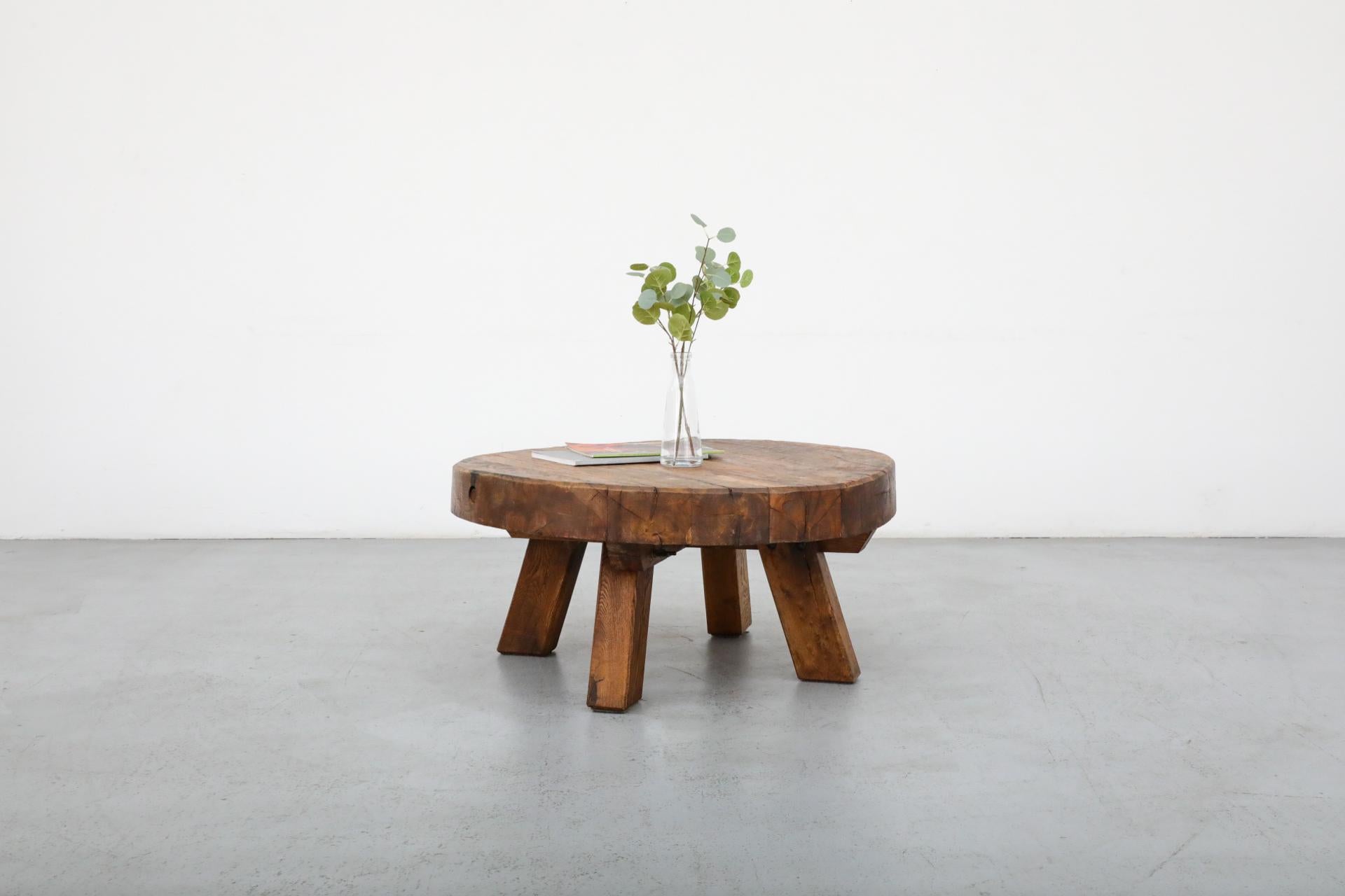 Heavy Brutalist round hand-carved solid oak coffee table with interlocking understructure, four squared legs and thick slab top. The underside of the top has a wabi-sabi line to it, while the top is level. Incredible piece. In original condition