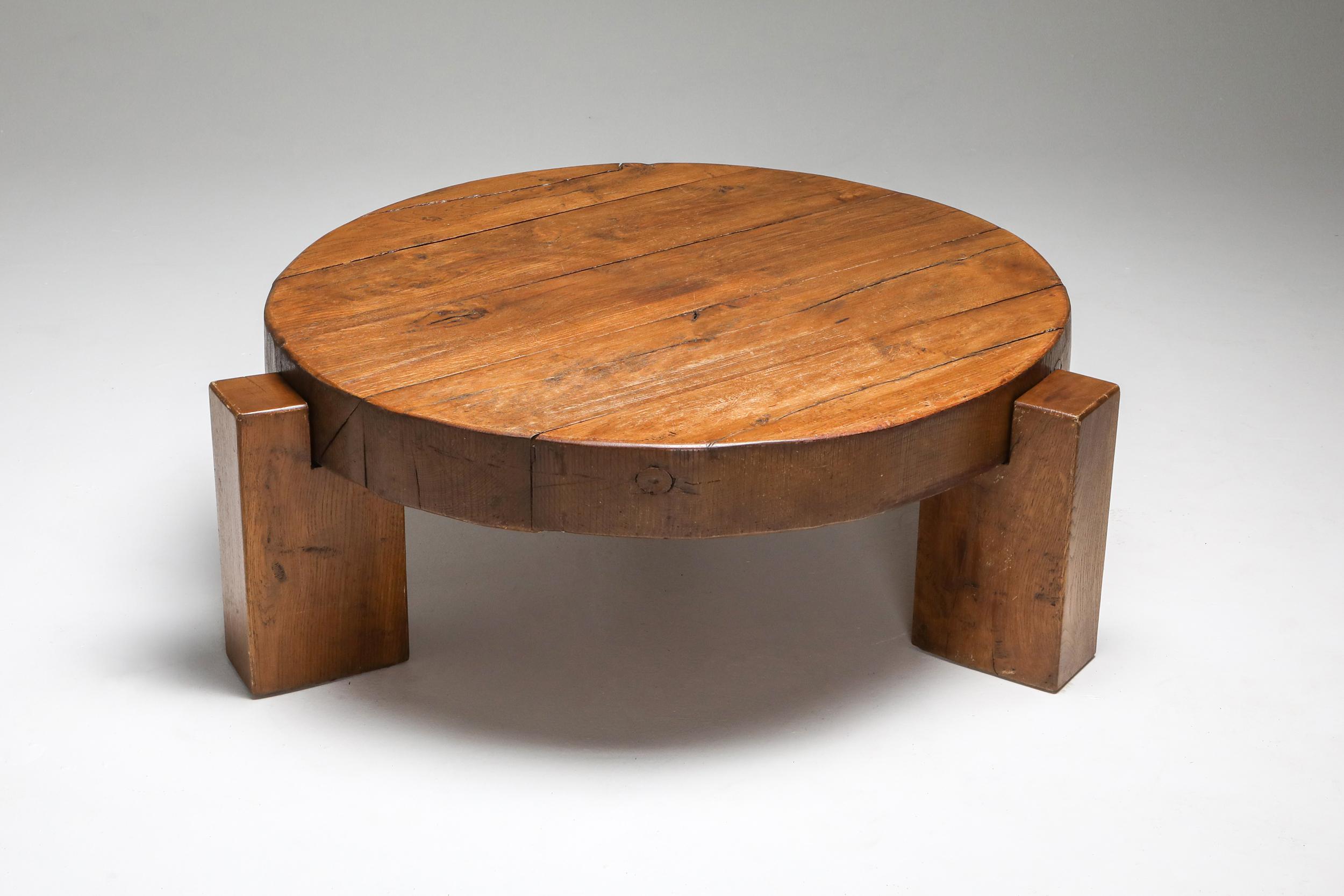 Rustic modern round coffee table in solid oak with three legs, made in Europe, the 1960s. 

Would fit well in a Pierre Chapo inspired interior. Integrates Brutalist and wabi-sabi qualities in one-piece.
   
      