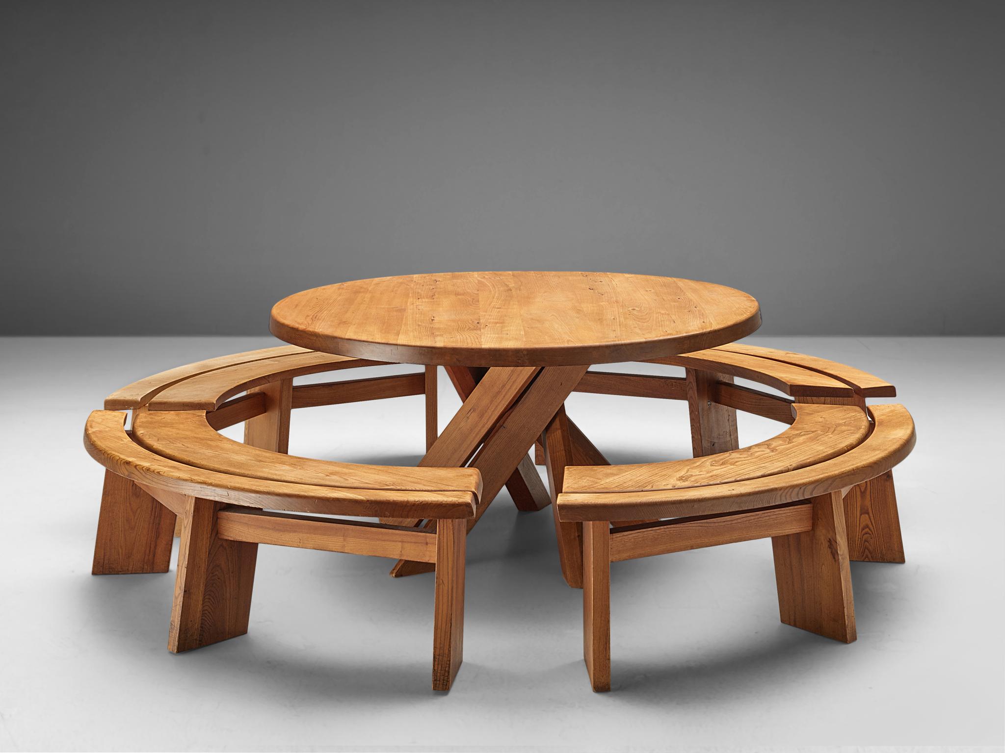 Pierre Chapo, dining table T21 'Sfax', elm, France, 1960s.
(benches excluded)

This round dining table with five legs is designed by Pierre Chapo. The shape of the base creates a very open look and makes this an object to make a space more