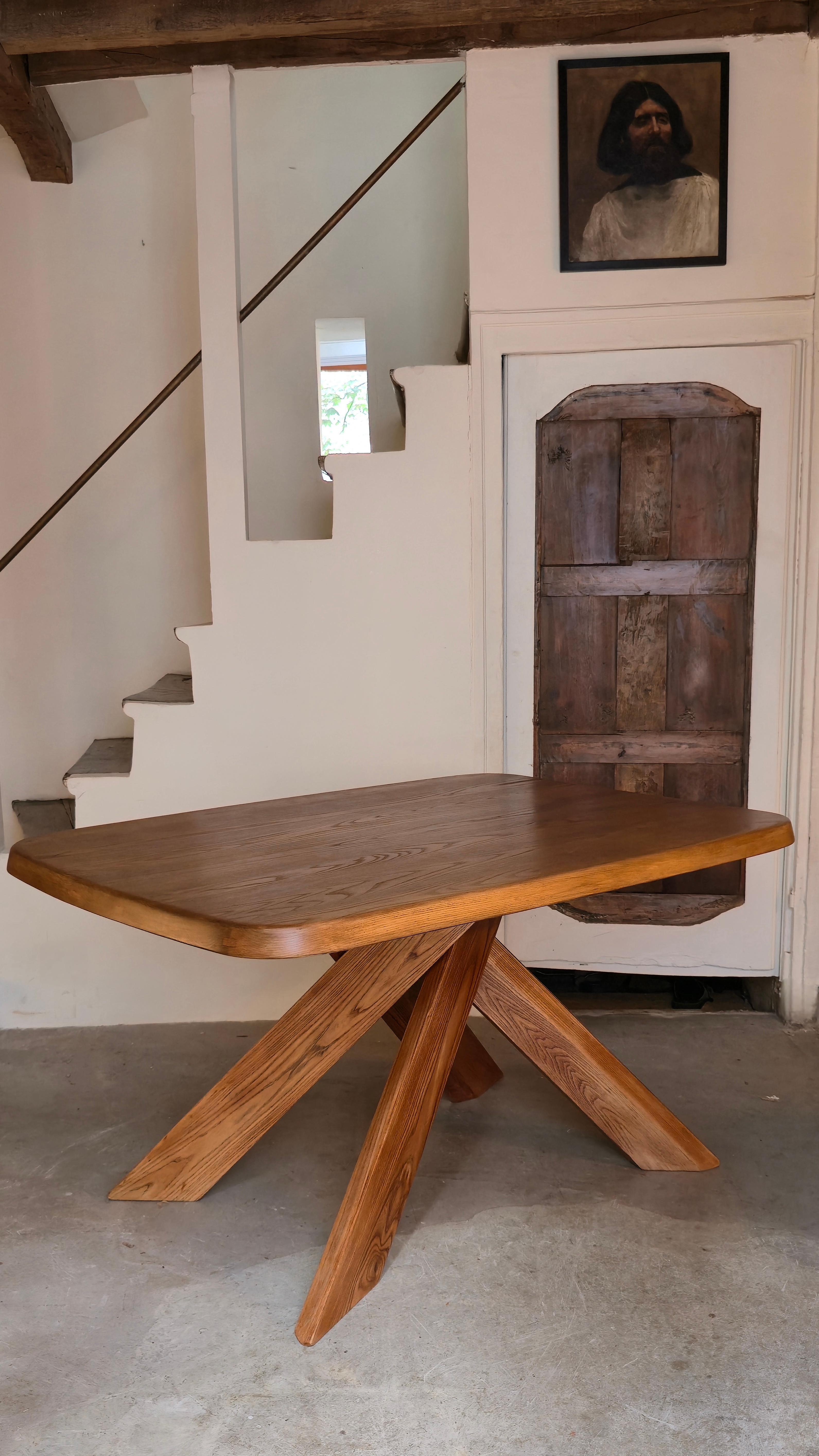 A rare and iconic 'T35B' dining table by renowned French designer Pierre Chapo, crafted in the 1970s. Constructed from solid elm, this piece exemplifies Chapo's commitment to pure and clean design principles. The table features a distinctive