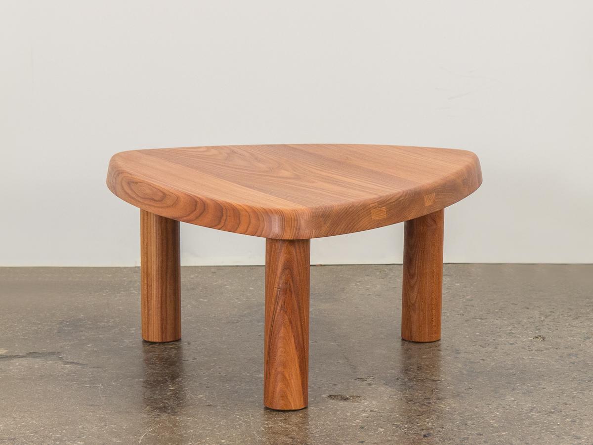Model T23 occasional table designed by Pierre Chapo. Exquisitely crafted from elmwood, this table features a thick triangular surface on sturdy, round legs. This table is flexible in its petite size and can function as a side table or coffee table.