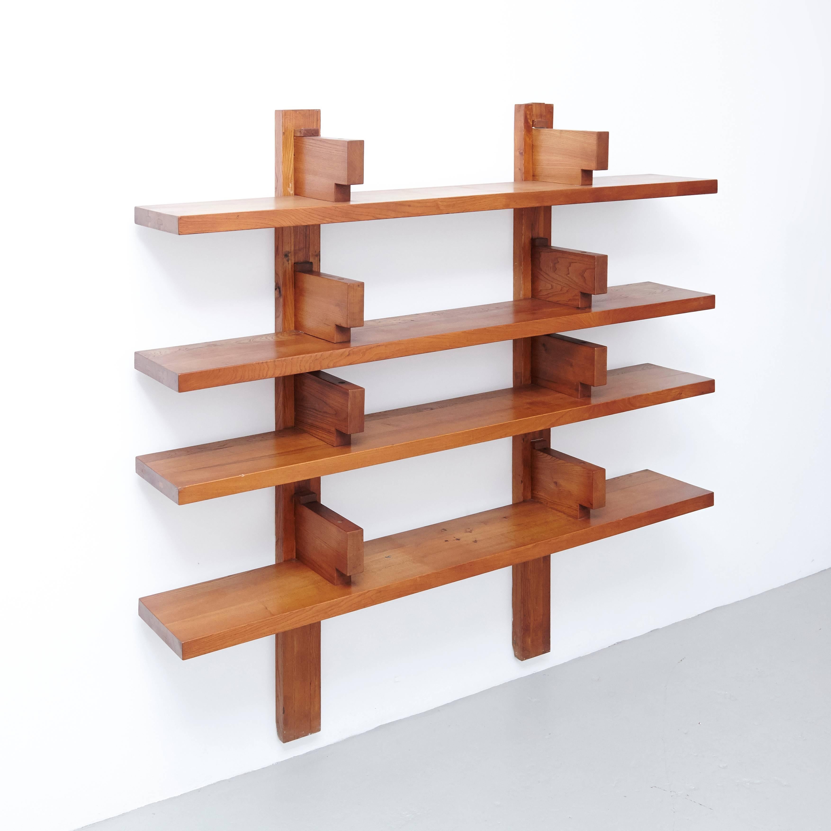 Wall-mounted book shelves designed by Pierre Chapo, circa 1960 in France.

elmwood

In original condition, with wear consistent with age and use, preserving a beautiful patina.

The lower back part of the wood structure has some looses on the