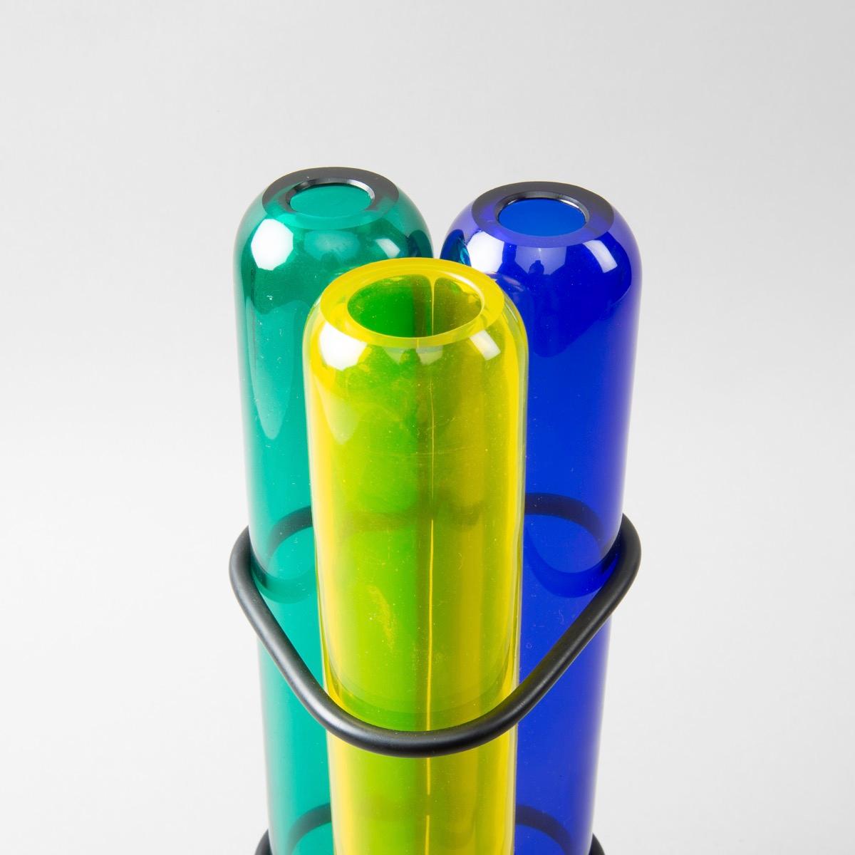 A rare vase designed by Pierre Charpin in 2003, manufactured the same year at Venini.

A very simple and efficient idea of 3 mouth blown glass (blue, green and yellow) tubes joined together with rubber o-rings.

The piece is signed with diamond
