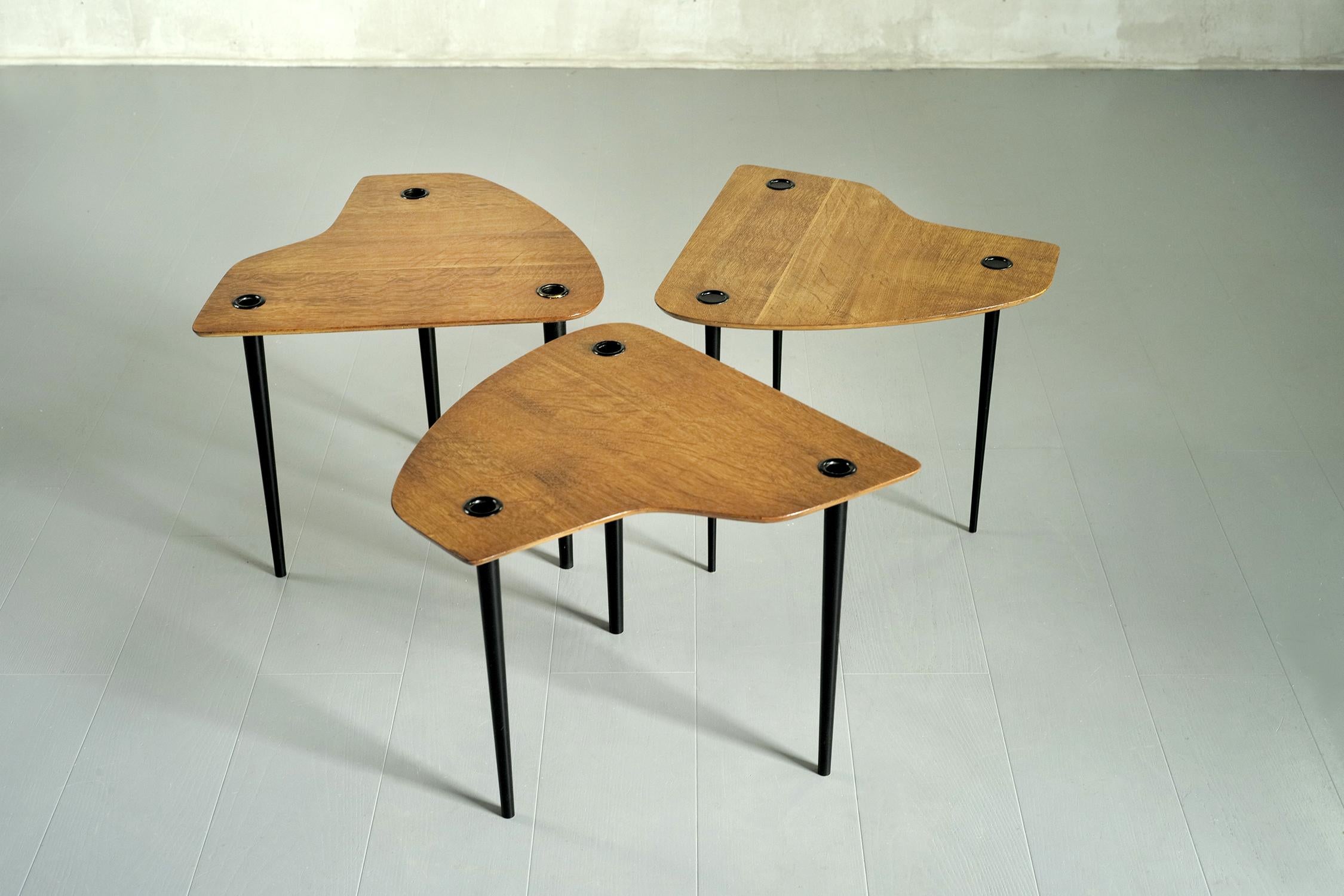Set of three tripod tables in oak and blackened brass by Pierre Cruège, Formes edition, France 1950. Called 