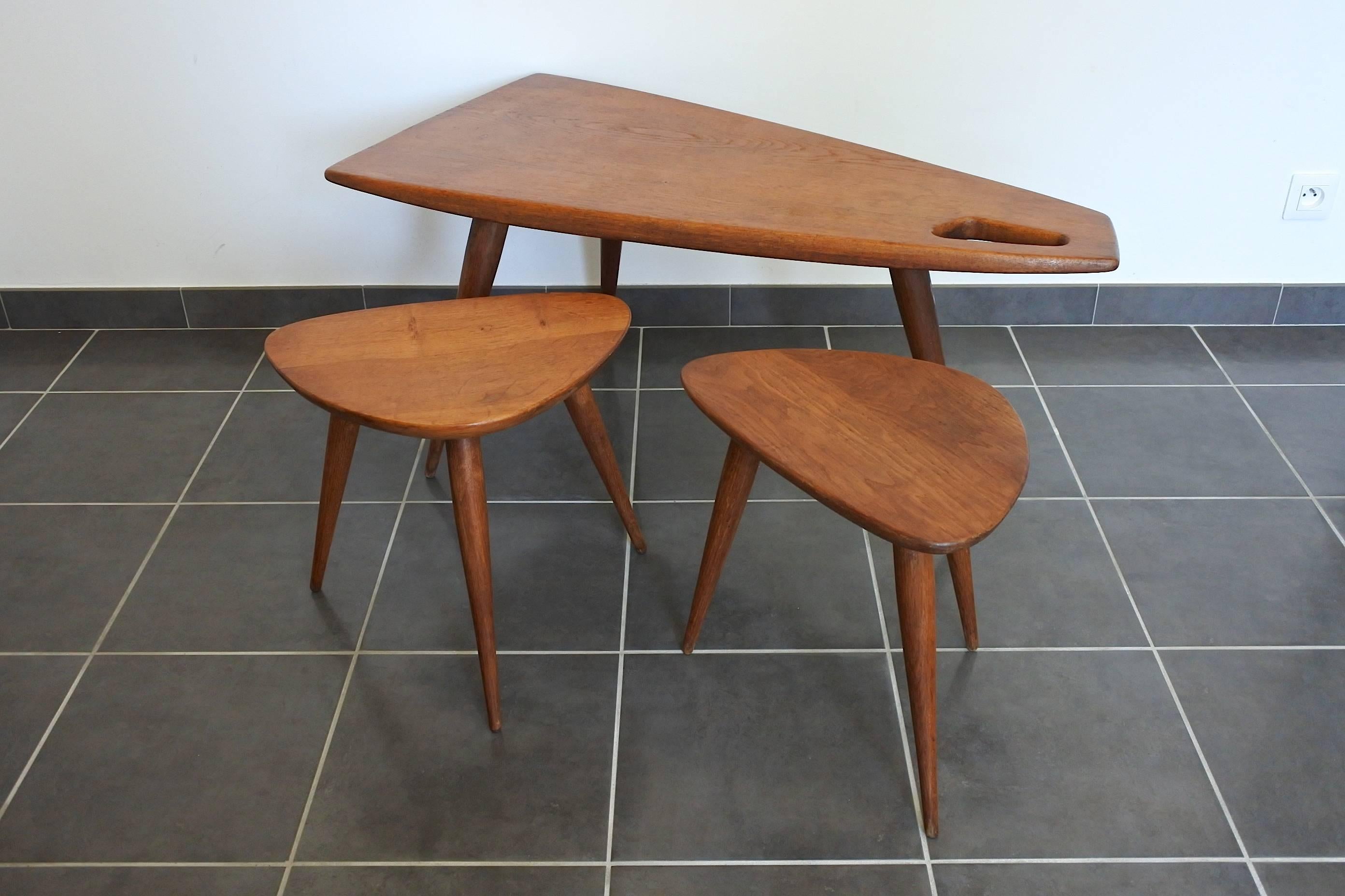 Rare set of three documented free-form tables by French designer Pierre Cruege and edited by Formes.
One tripod coffee table and two tripod side tables in solid oak wood.
France, circa 1950

Outstanding quality for this set and great