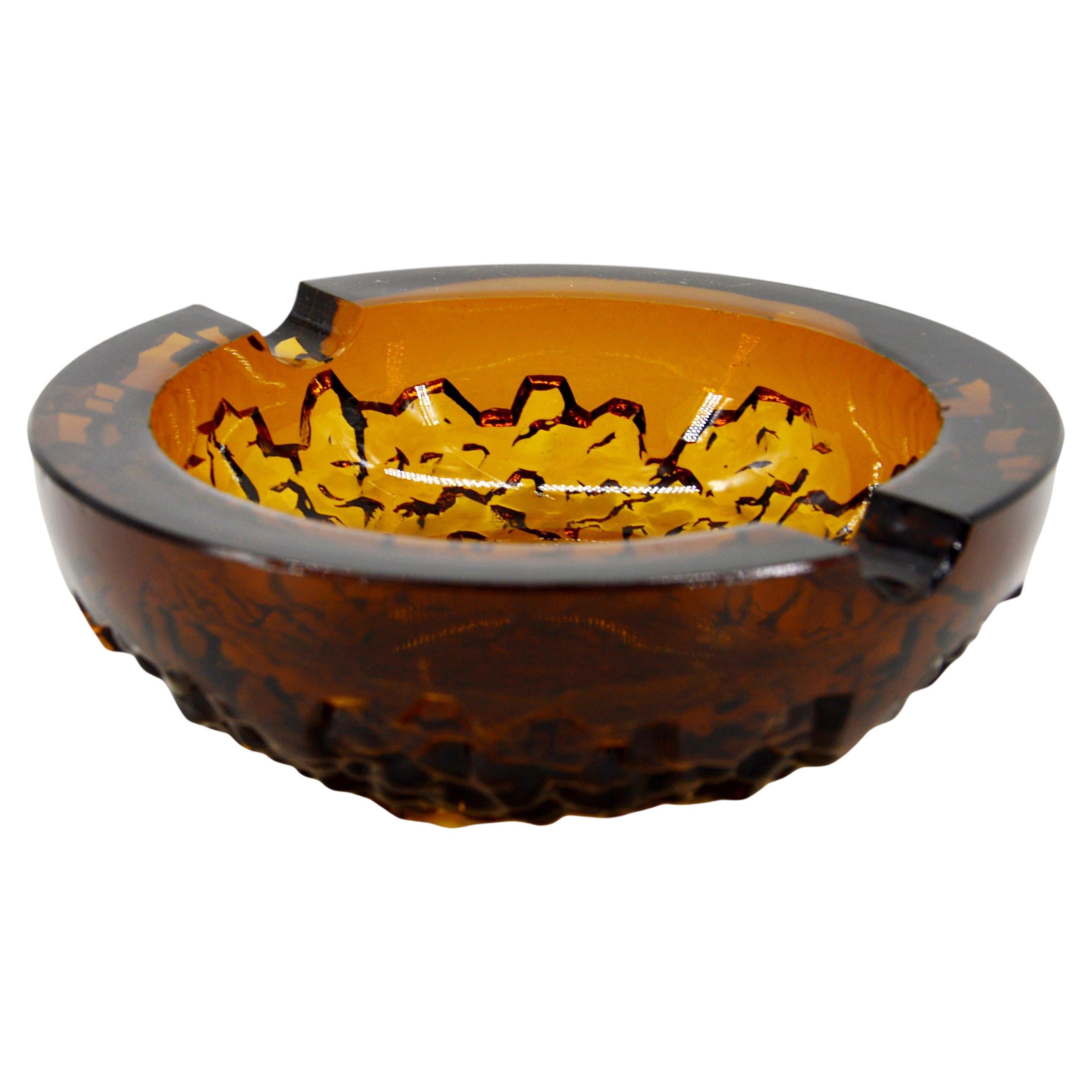 This exquisite ashtray is a stunning example of French Art Deco design, created by Pierre D'AVESN for VERLYS, Les Andelys, France, in the late 1930s. Crafted from thick molded glass, this piece features the clean lines and geometric elegance