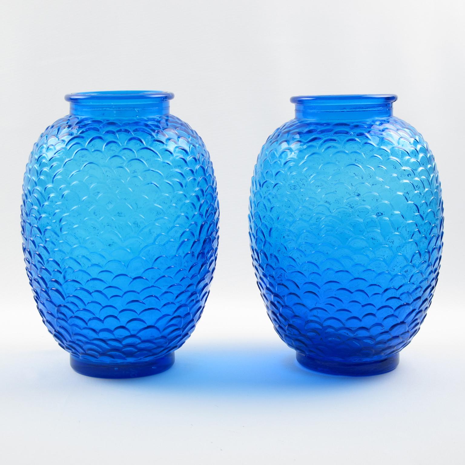 Stunning Pierre D'Avesn pair of electric blue glass vases. Molded pressed glass vases in a shouldered form with a cast and stylized snakeskin textured pattern. Impressive blue color. Produced by glass factory Cristallerie de Choisy-le-Roi. No