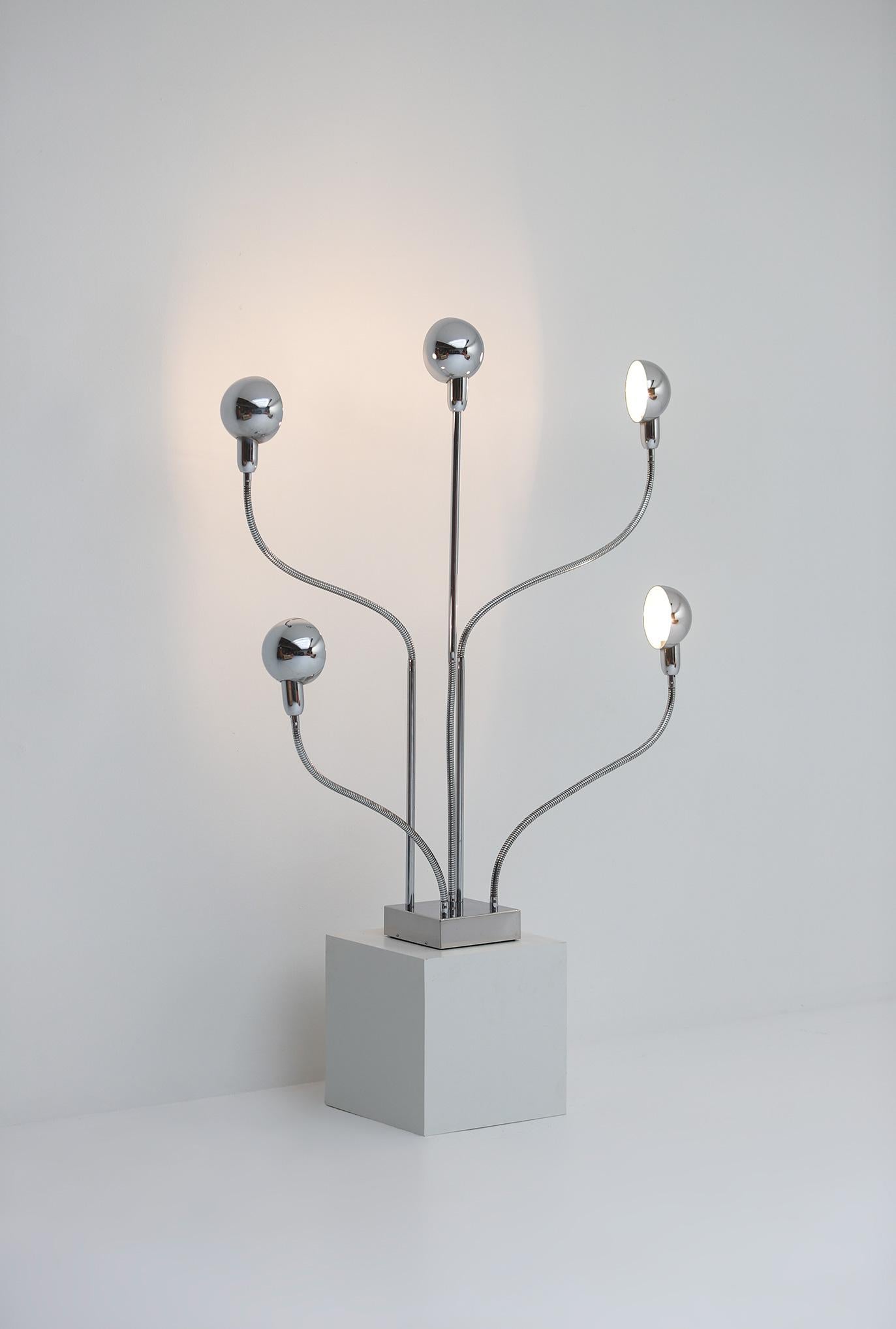 The Hydra chrome floor or table lamp was designed by Pierre Folie and manufactured in France in 1969 by Jacques Charpentier. This playful lamp has five directional branches that can be positioned in multitude directions to achieve the perfect