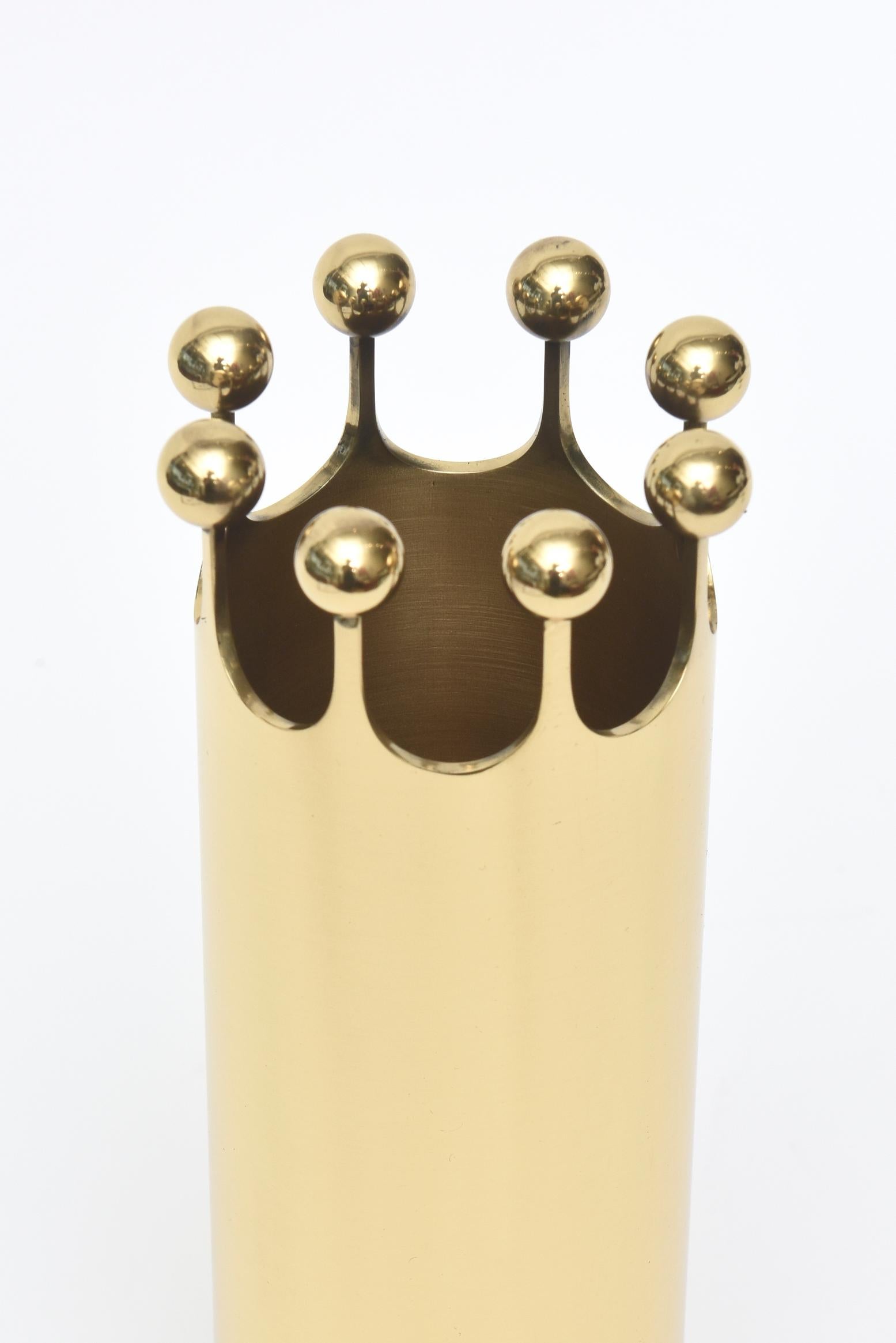 This rare cylinder solid brass vase designed by Pierre Forsell for Skultuna Sweden has a crown motif. It has been professionally polished and then lacquered so it will not tarnish. You must now only use a cotton cloth to clean it. No polish or harsh