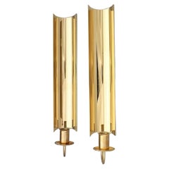 Pierre Forsell for Skultuna. Two 'Reflex' wall-mounted candlesticks in brass.  