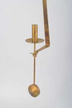 Pierre Forsell, Skultuna. Wall candle holder in brass with pendulum suspension