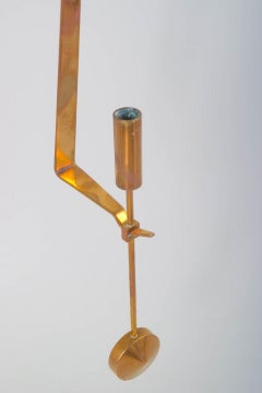 Pierre Forsell, Skultuna. Wall candle holder in brass with pendulum suspension