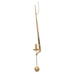 Pierre Forsell, Skultuna. Wall candle holder in brass with pendulum suspension