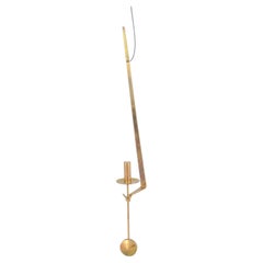Pierre Forsell, Skultuna. Wall candle holder in brass with pendulum suspension