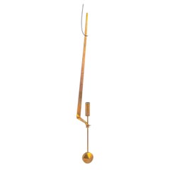 Pierre Forsell, Skultuna. Wall candle holder in brass with pendulum suspension