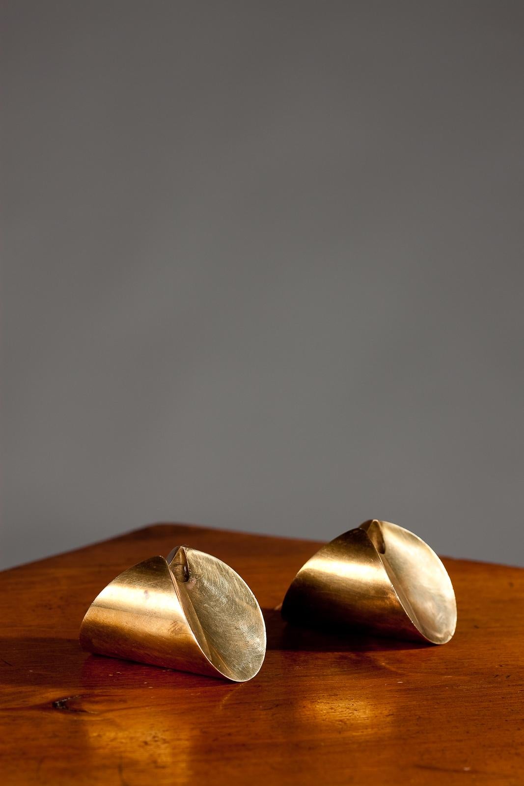 Add a touch of vintage elegance to your home decor with this rare pair of 1950's Pierre Forssell rocking tulip brass candlesticks by Skultuna. The unique rocking design allows for a gentle swaying motion, creating a soothing and mesmerizing effect
