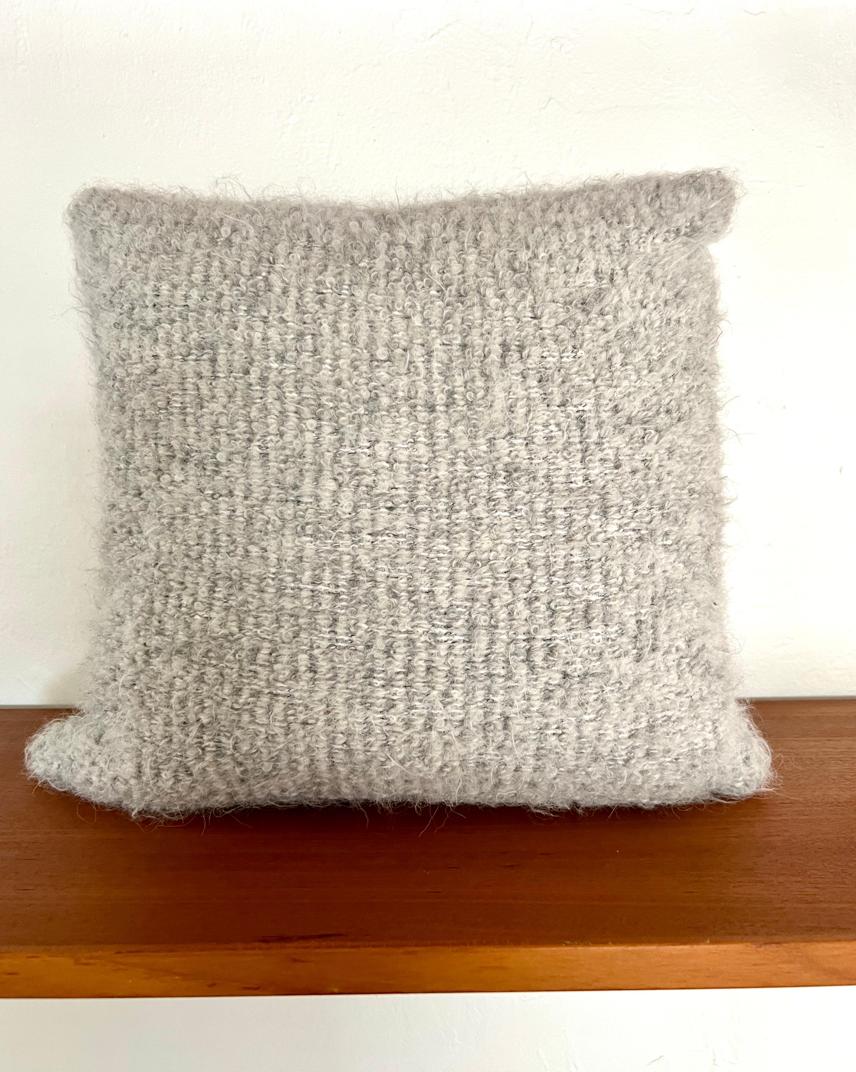 Luxury decorative pillow made with Pierre Frey’s Scarlette Plume fabric, featuring a blend of alpaca, mohair, and merino wools to create this stunning woven texture. The reverse side of the pillow is equally as beautiful and features full grain