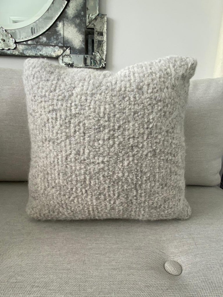 Handcrafted pillow made with Pierre Frey’s Scarlette in color Plume, featuring a blend of alpaca, mohair, and merino wools to create this stunning woven texture. The reverse side of the pillow is equally as beautiful and features full grain taupe