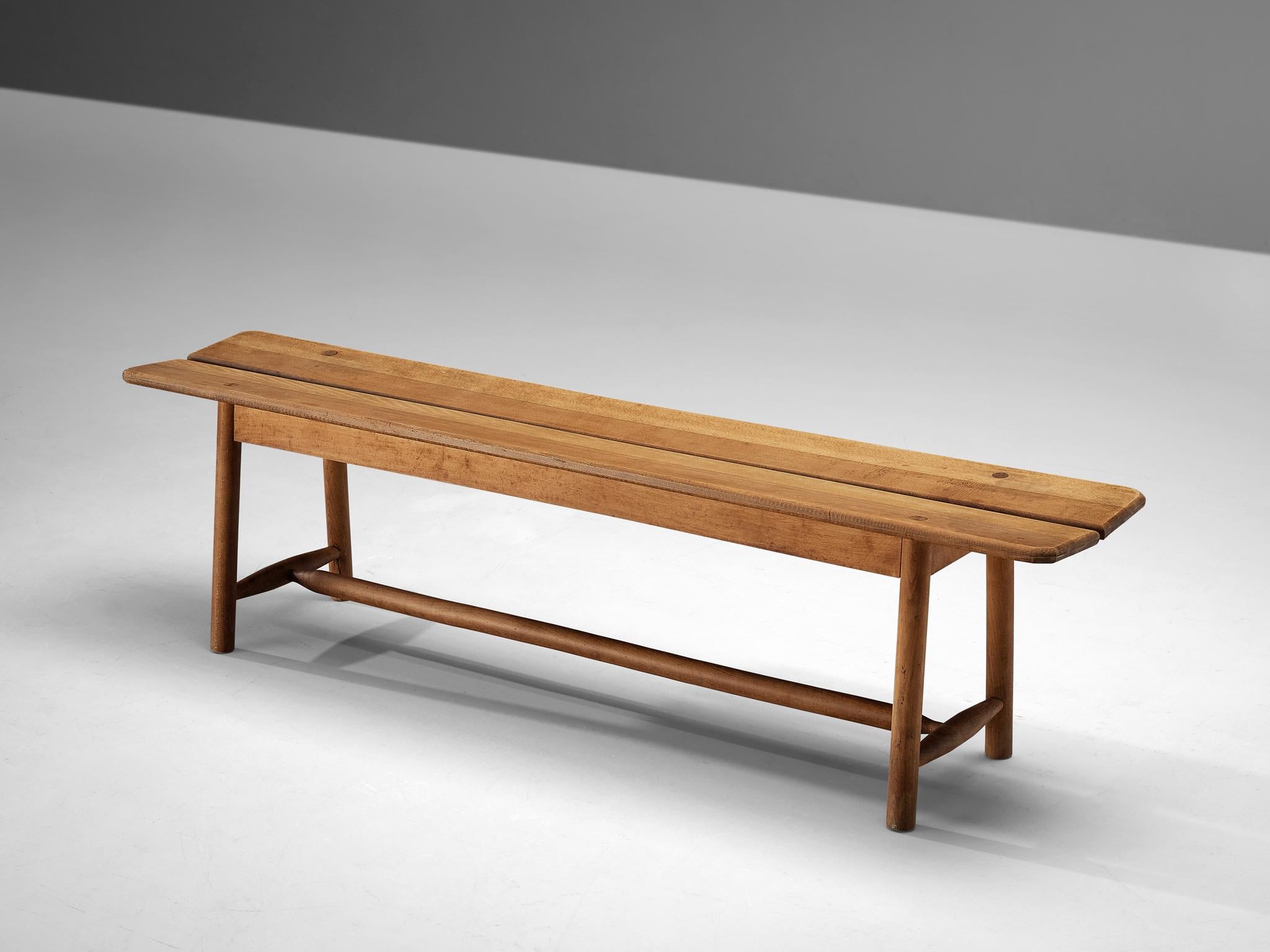 Pierre Gautier-Delaye, bench, solid beech, France, 1950s.

Simplistic bench by French designer Pierre Gautier-Delaye. The sleek design shows a beautiful line, which is emphasized by the open space in the middle of the bench. Moreover, the quality of