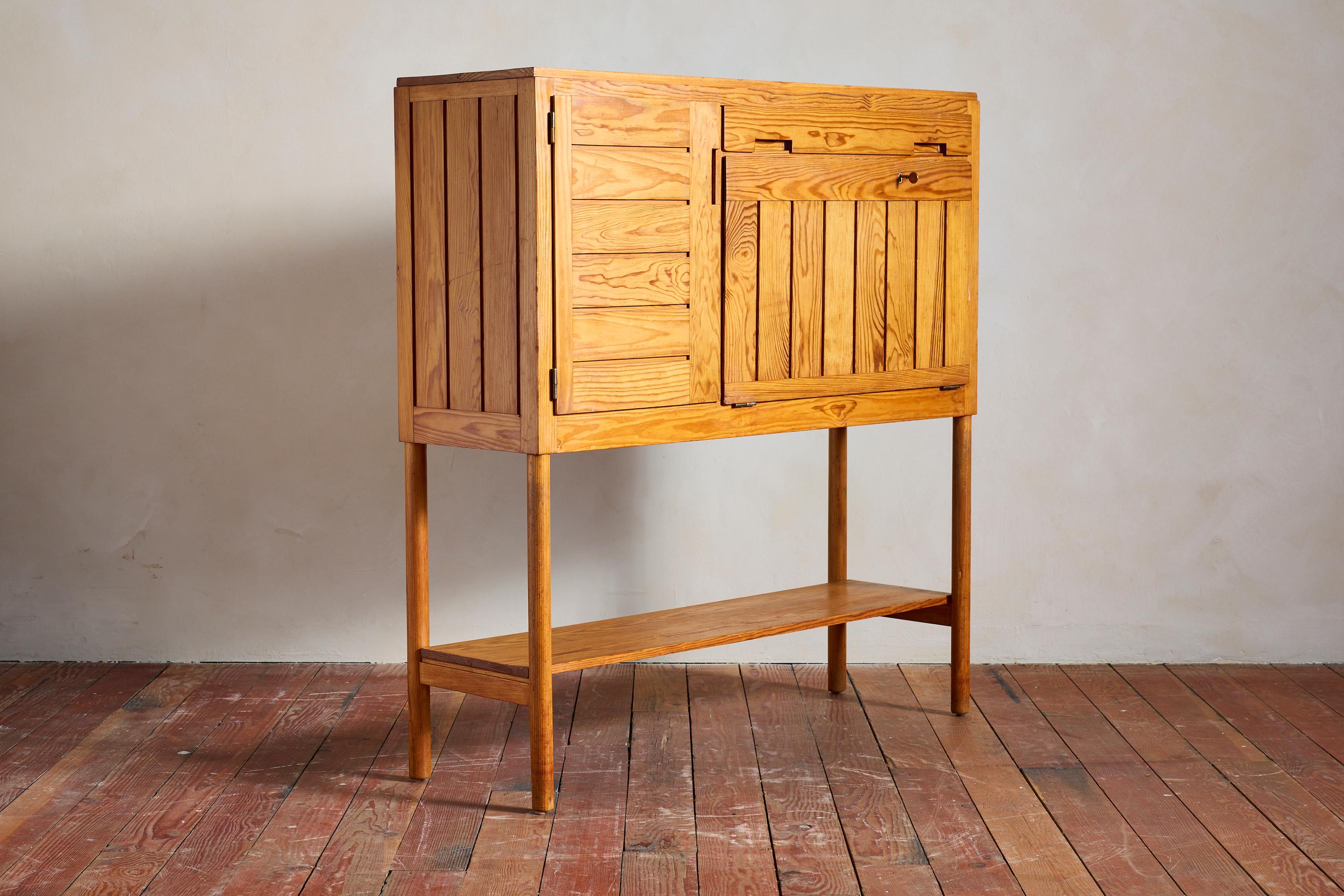 Pierre Gautier-Delaye cabinet with drop down secretary desk 
Rare design of the renown designer - France, 1950's 

Cabinet is constructed of fir wood with open doors that reveal shelving on the left , single pencil drawer and interior desk