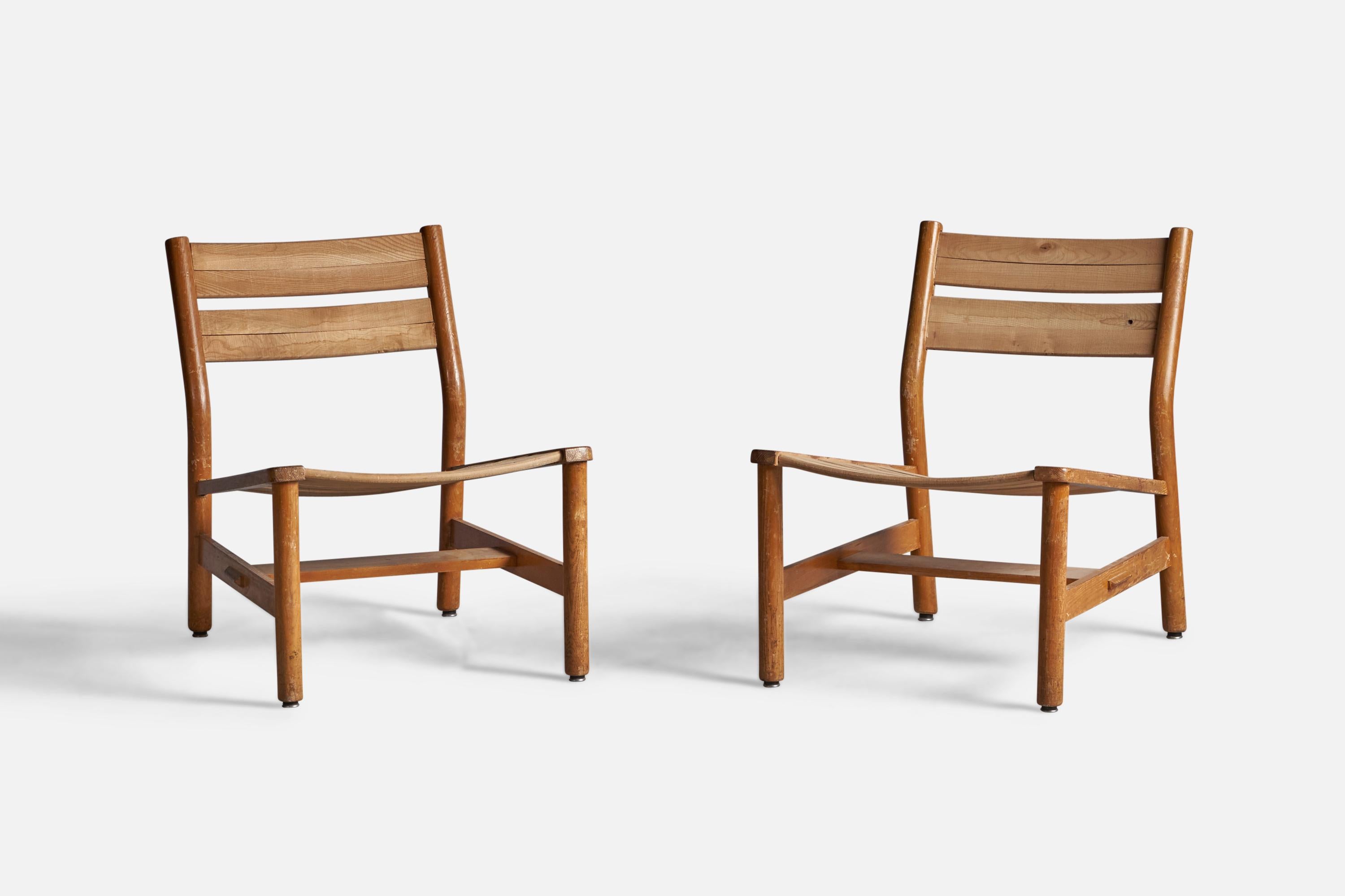 A pair of oak slipper chairs designed and produced by Pierre Gautier Delaye, France, c. 1950s.

14.75