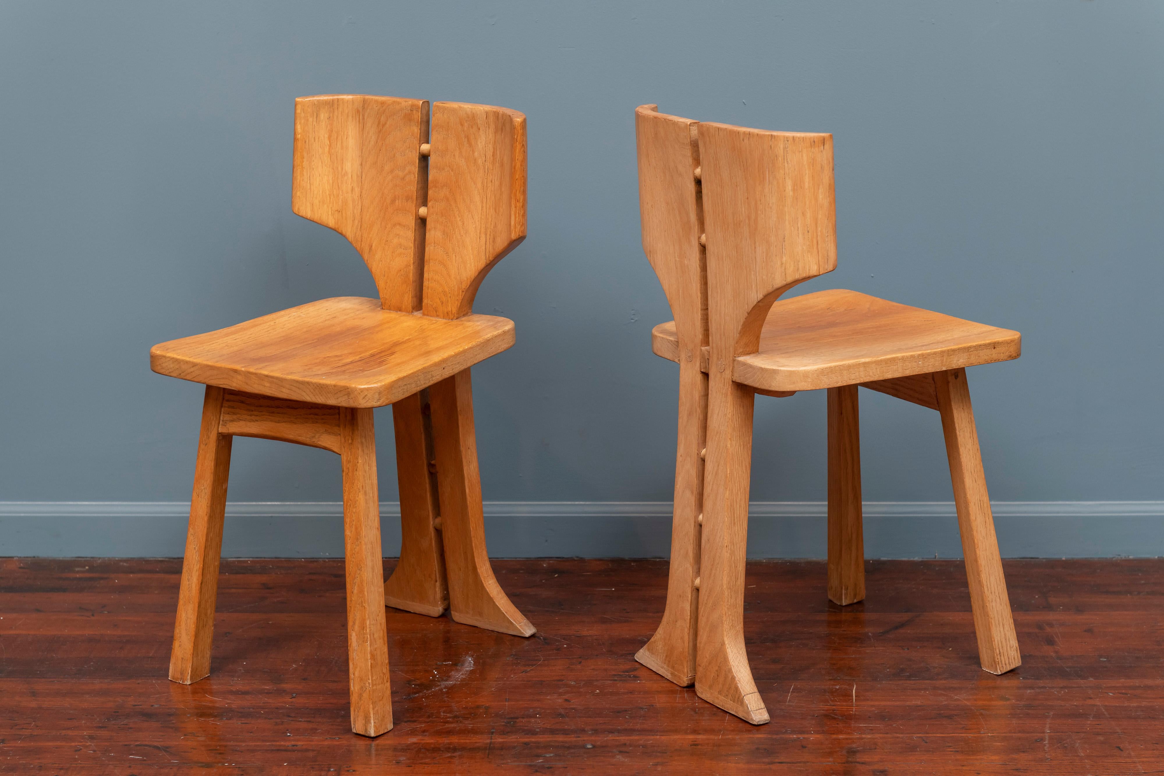 Pierre Gautier-Delaye design side chairs with stylized split backs, curved seat and supports. Made in oak with an eye-catching form these would serve as accent or pull up chairs for a modernist pop art interior.
