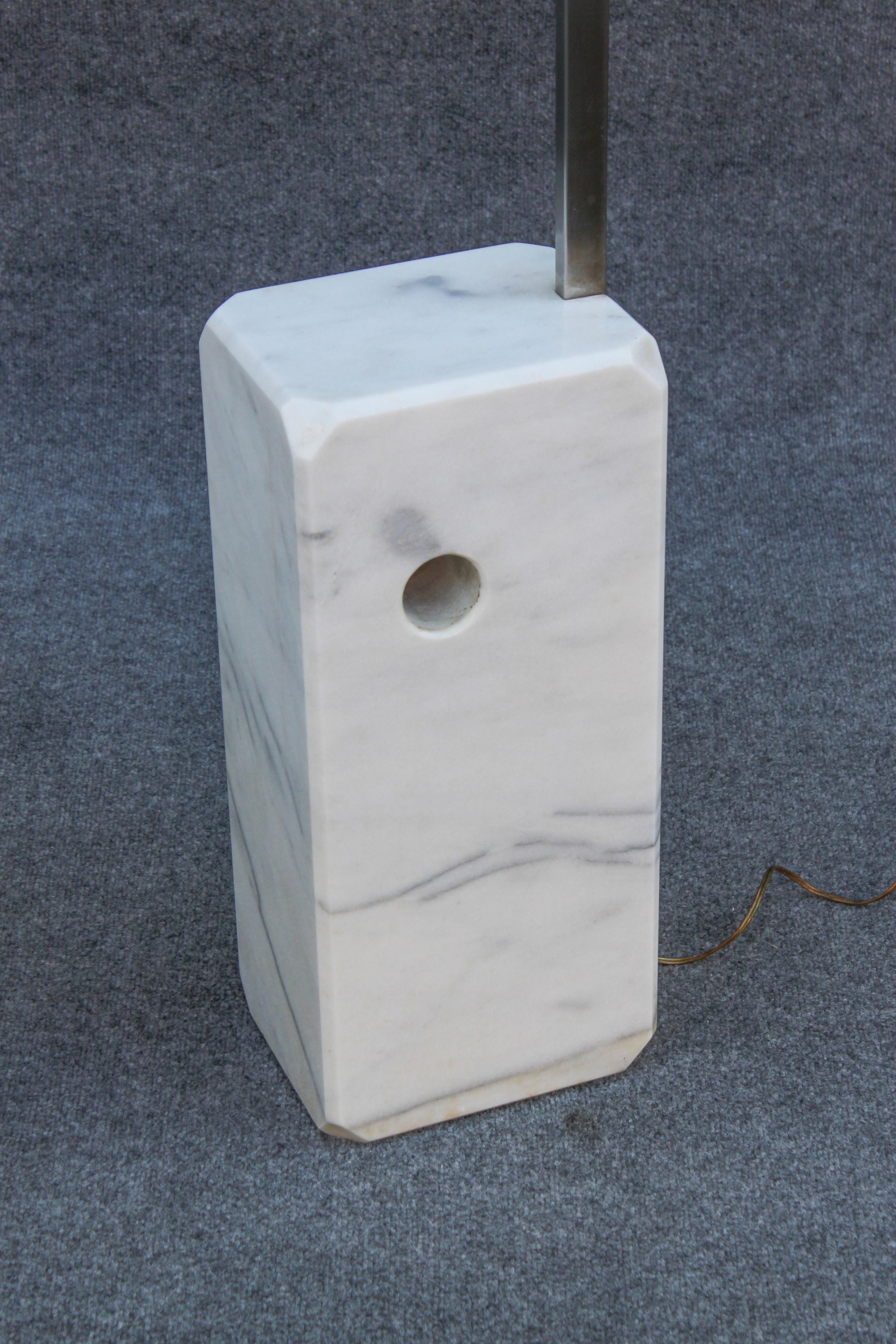 The Carrera marble base has very slight, barely noticeable yellowing. Telescoping arm shows signs of light oxidation, but operates well. The polished and coated/sealed aluminum shade shows light scuffs and scratches. Wiring is original. Lamp works