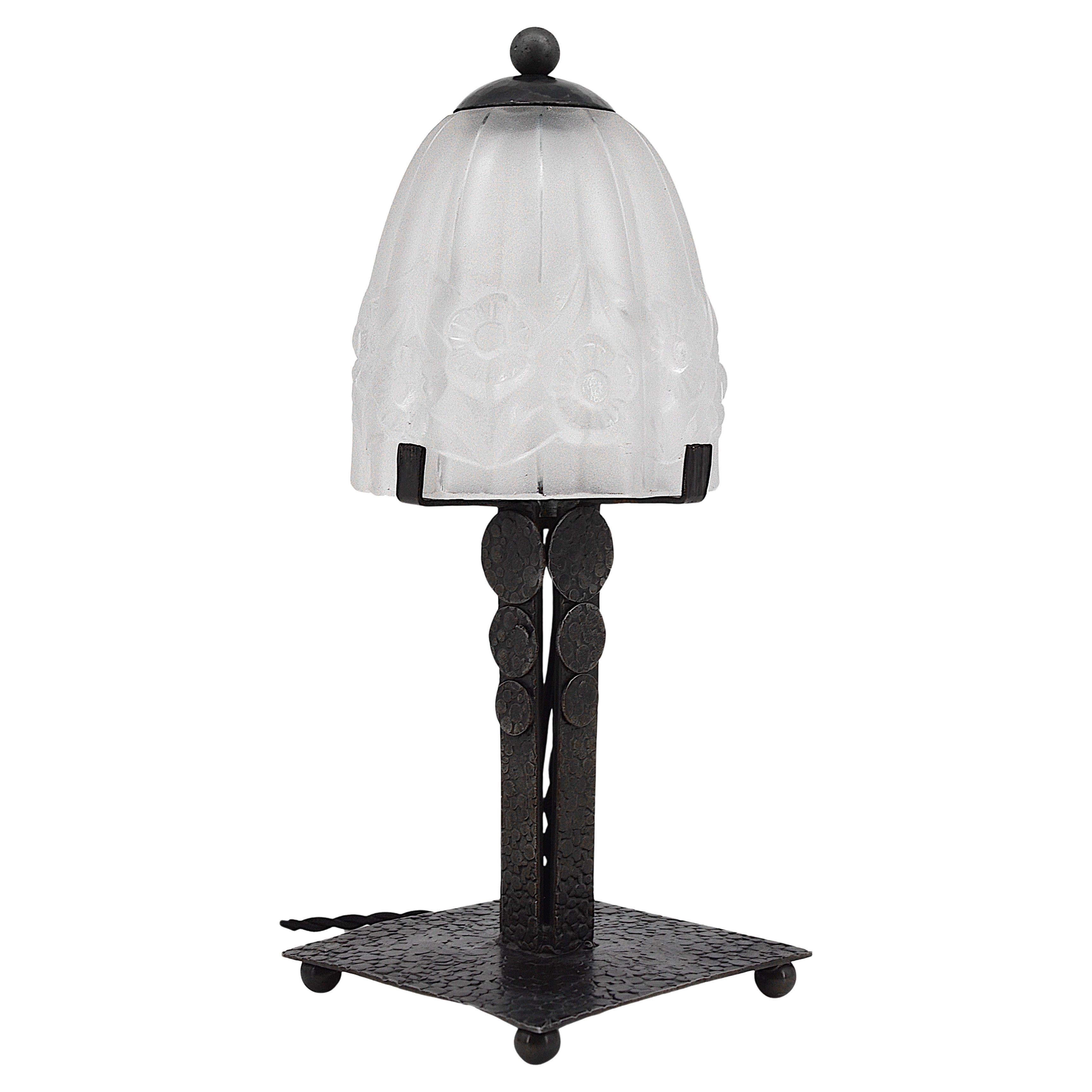 French Art Deco table lamp by Pierre Gilles, 27 rue Esquirol, Paris 13e, France, ca.1930. Thick molded glass shade on its classy wrought-iron base. Measures: Height: 11