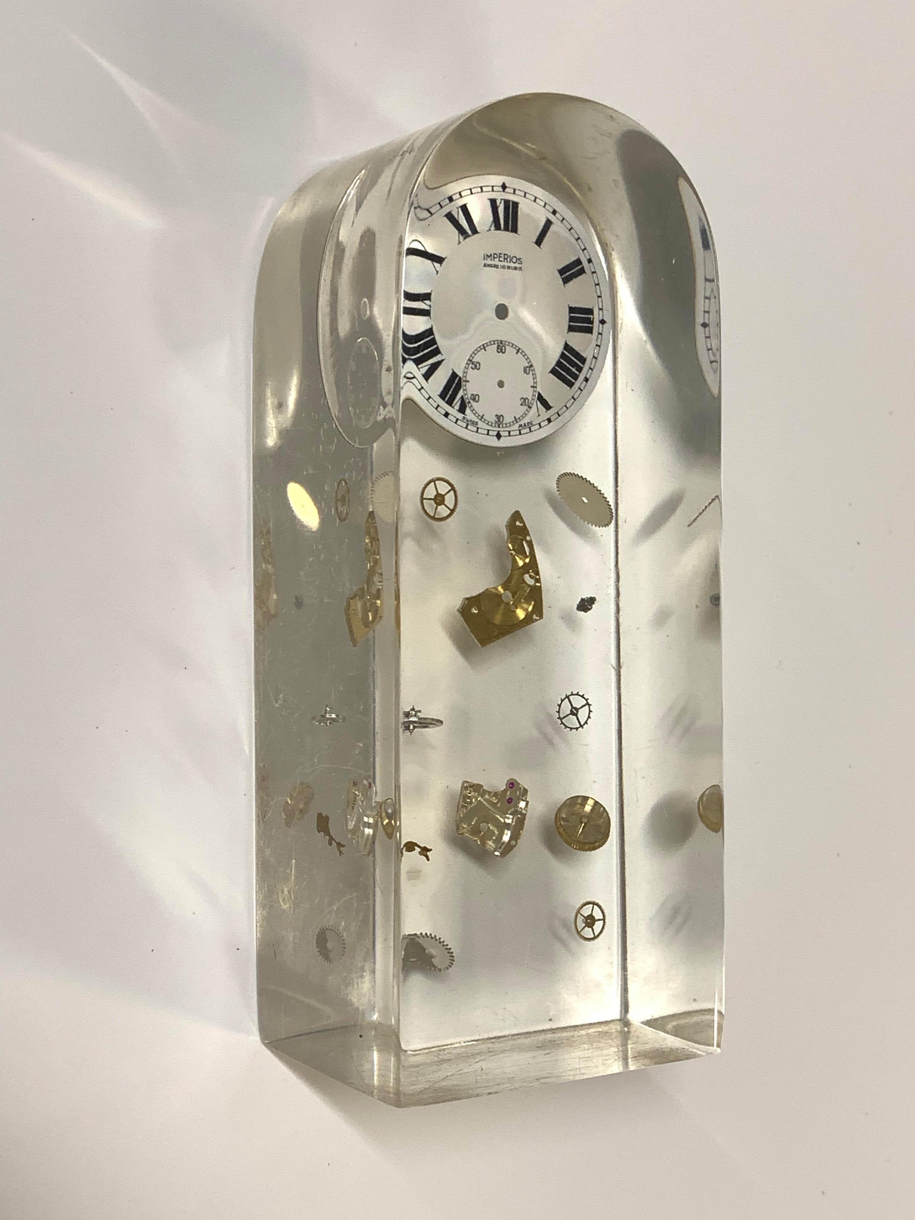 Rare cubic Lucite resin exploded sculpture clock. This piece was designed by Pierre Giraudon in France during the 1970s.

This item is amazing as it is an exploded clock sculpture, with all the components floating in crystal Lucite resin with an