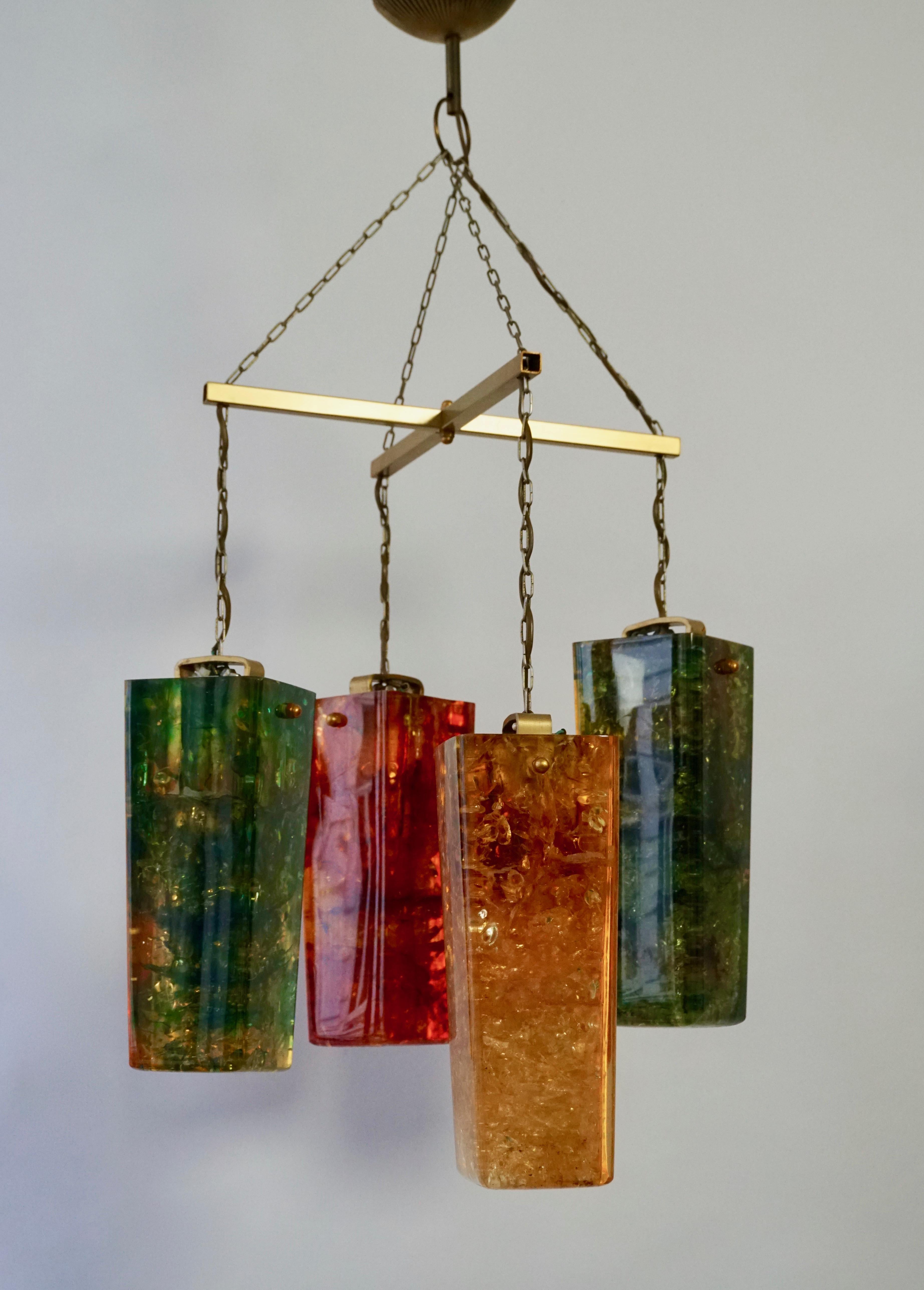 A rare and spectacular resin chandelier designed and edited by Pierre Giraudon, France, 1960-1970s.

Materials: 4 conical beams made of fractal synthetic resin, hollow inside. 2 in green, orange, and yellow. 1 in clear,  orange and yellow and 1 in